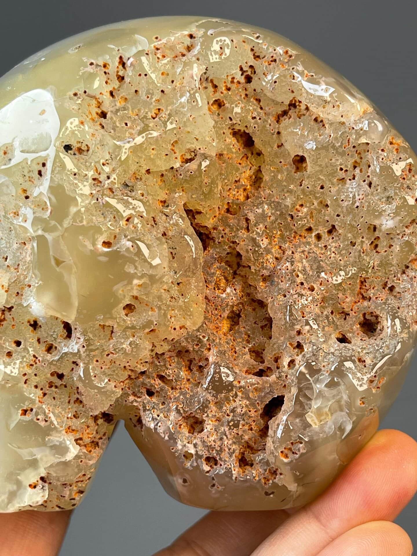 Artisan skull carving from flower agate with crystal hollow