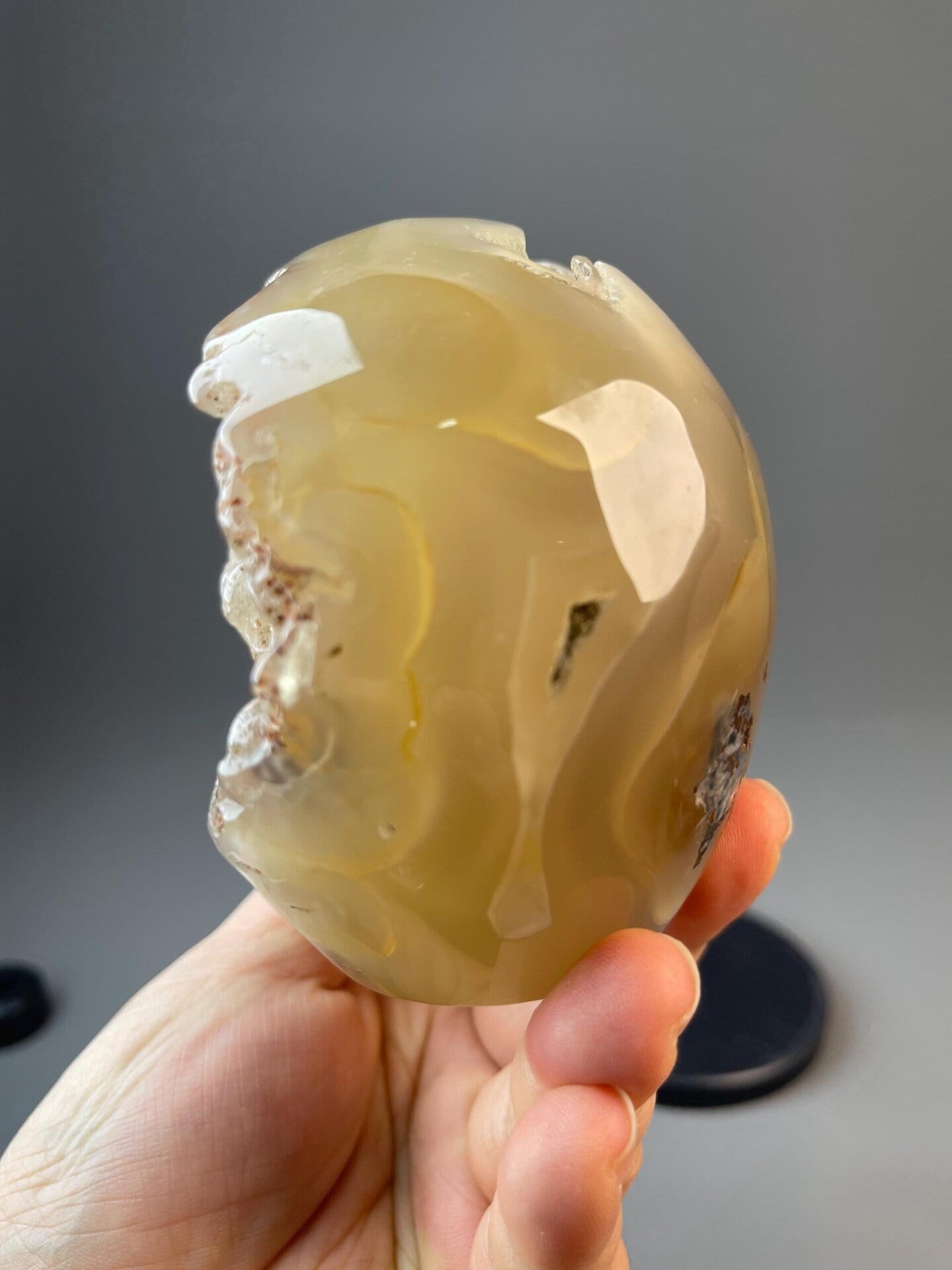 Carved mineral skull from flower agate with crystal accents