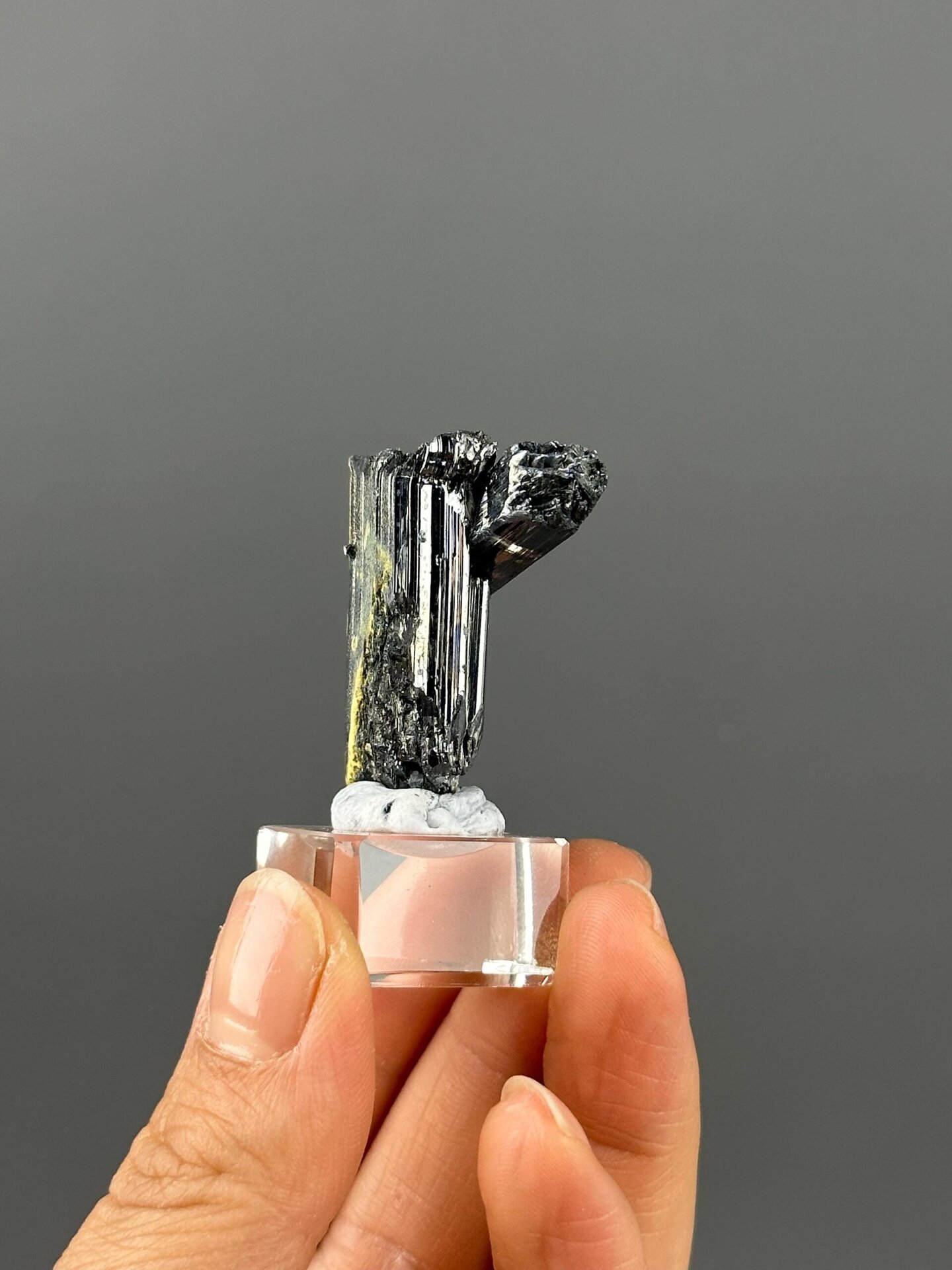 Back view of twin stibnite crystal specimen