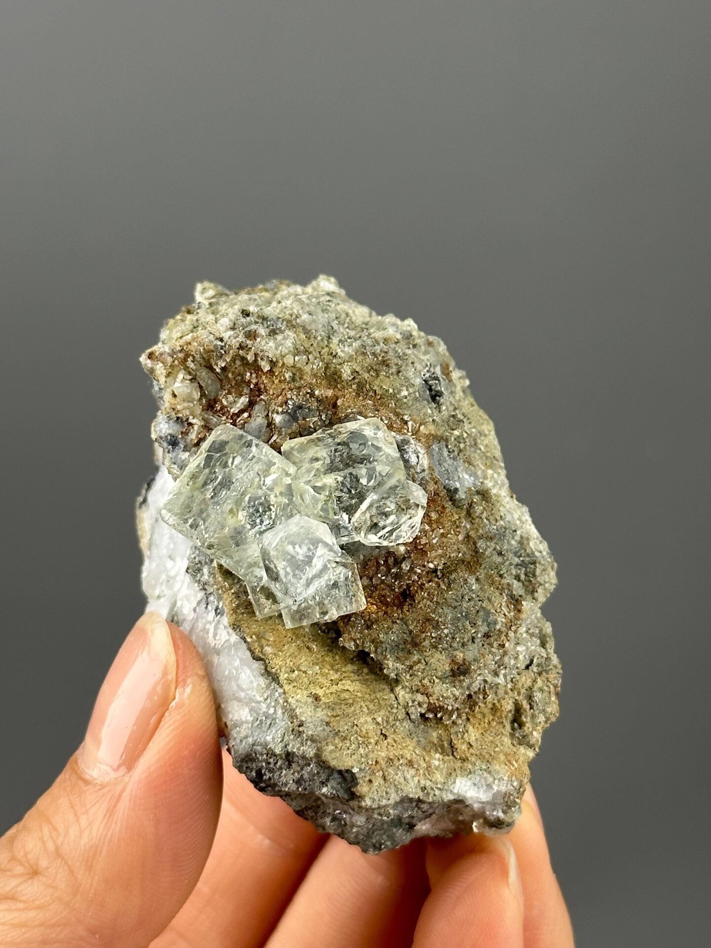 Matrix base supporting transparent green fluorite