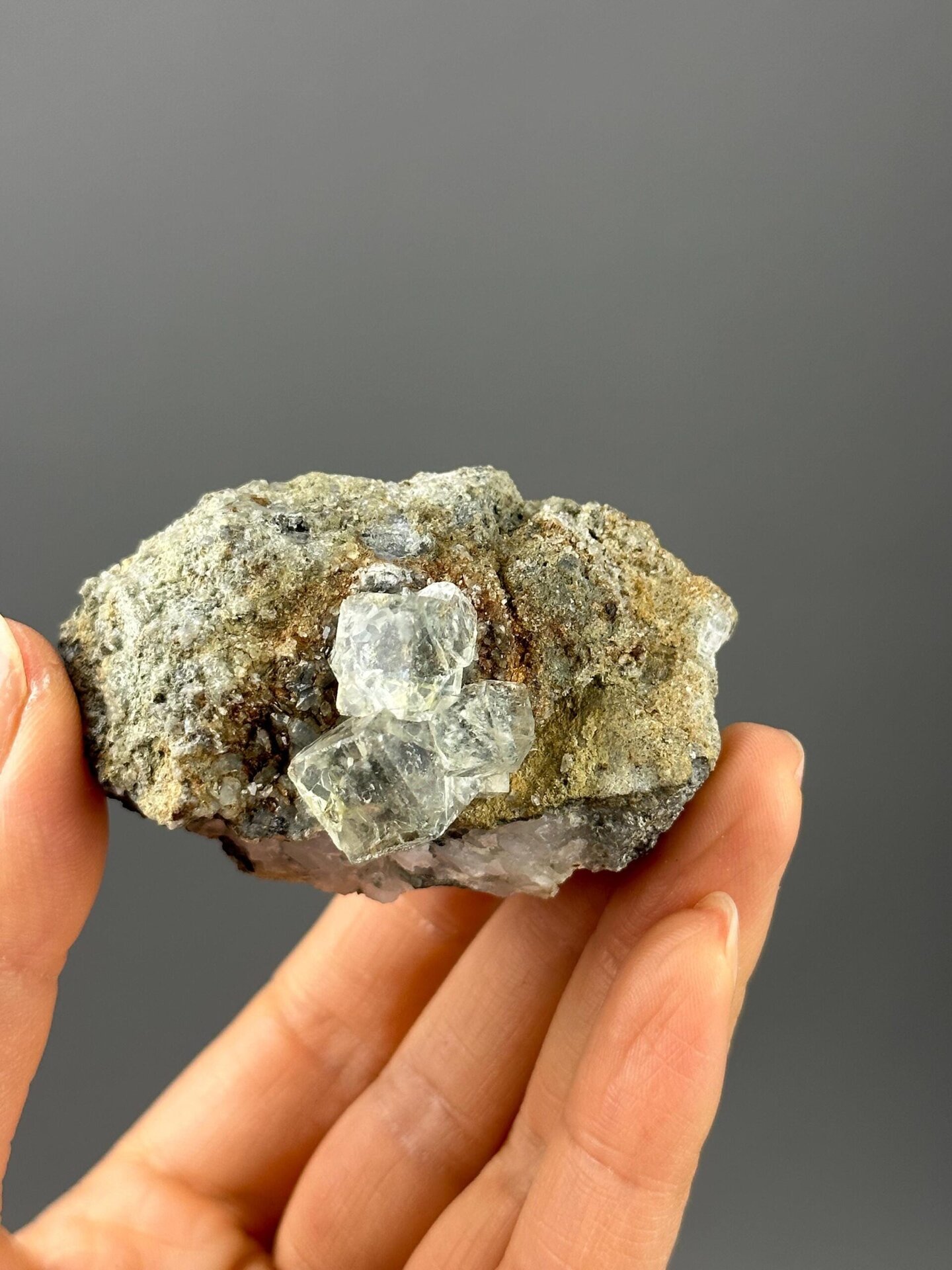 Side view of green fluorite crystal on rock matrix