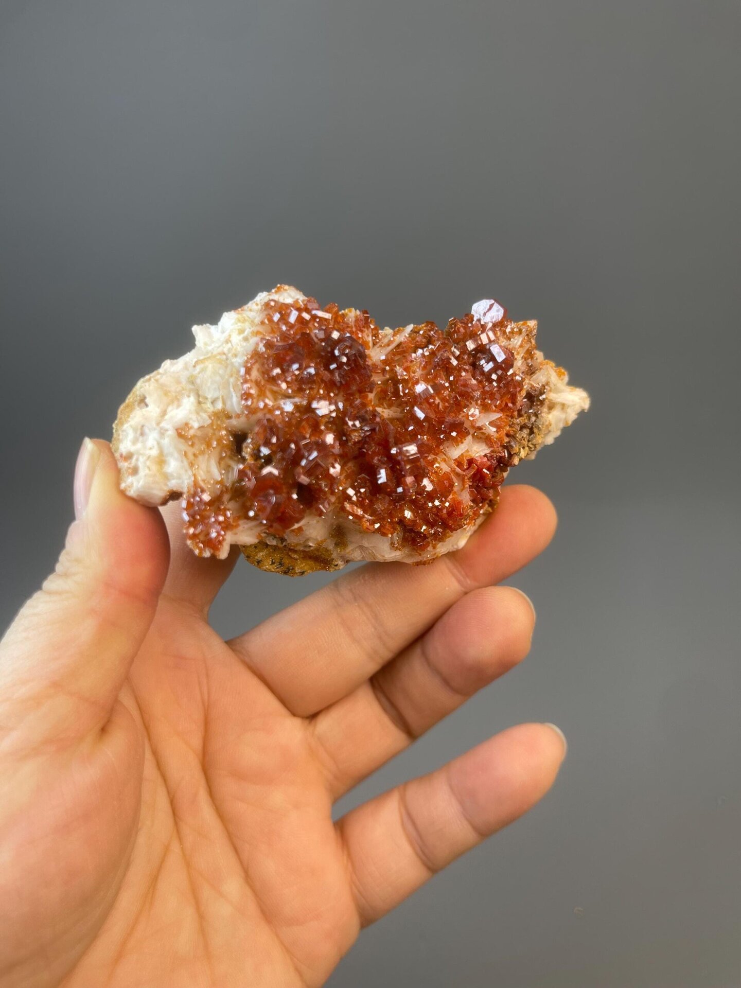 Red vanadinite hexagonal crystal cluster on natural matrix