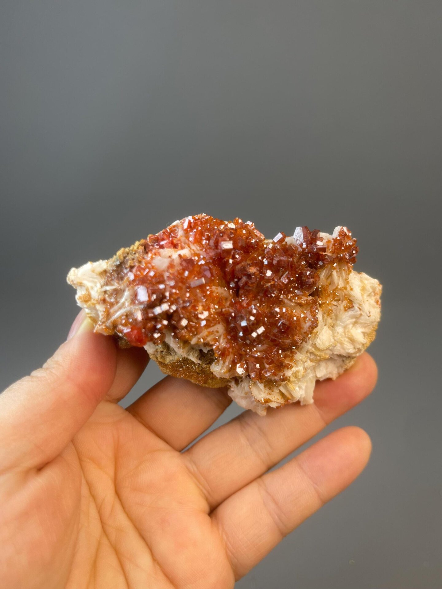 Bright red vanadinite crystals on contrasting mineral matrix