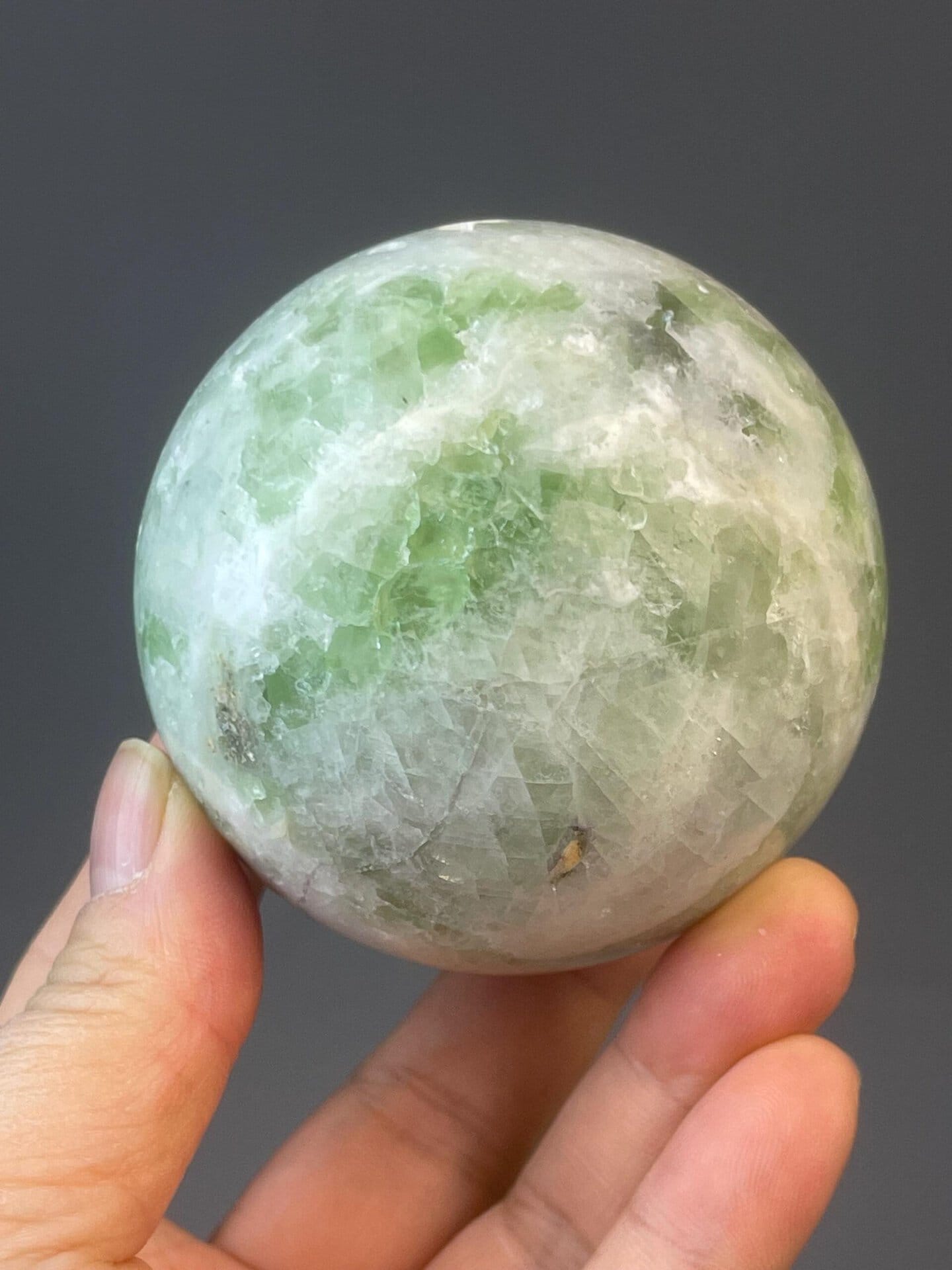 Carved green fluorite sphere measuring 2.6×2.6×2.6 inches