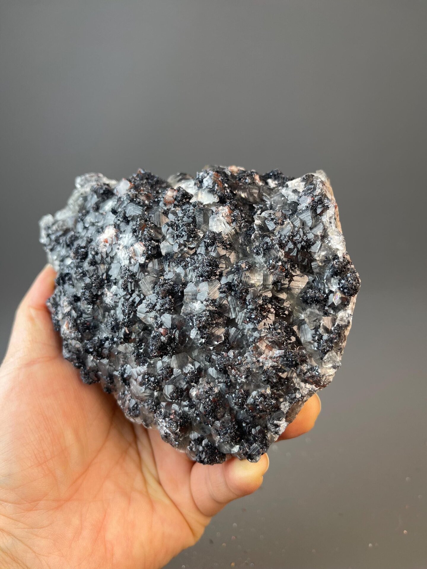 Dark gray hematite with red secondary layer and clear calcite