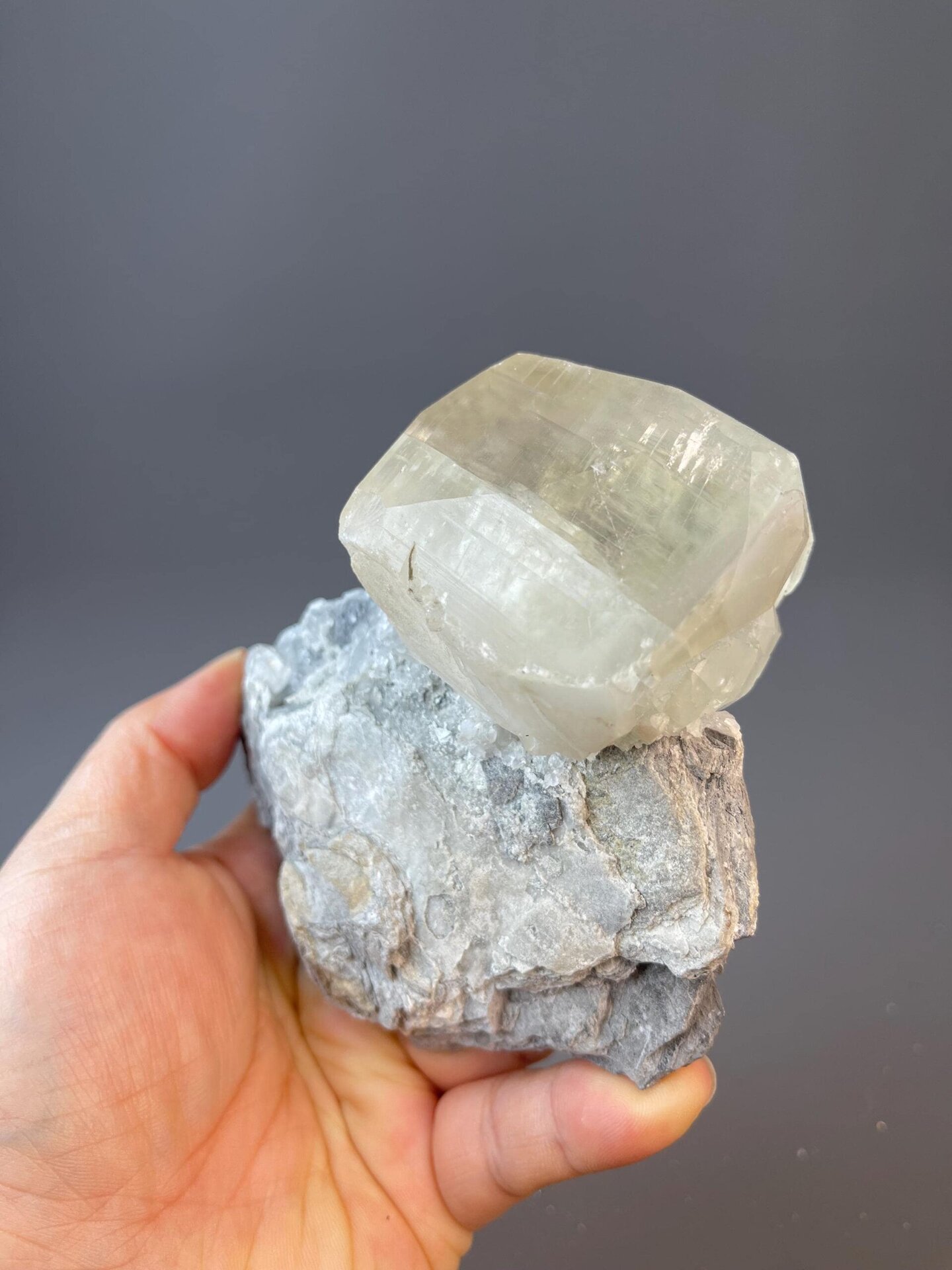 Yellow calcite globe with trigonal symmetry on gray matrix