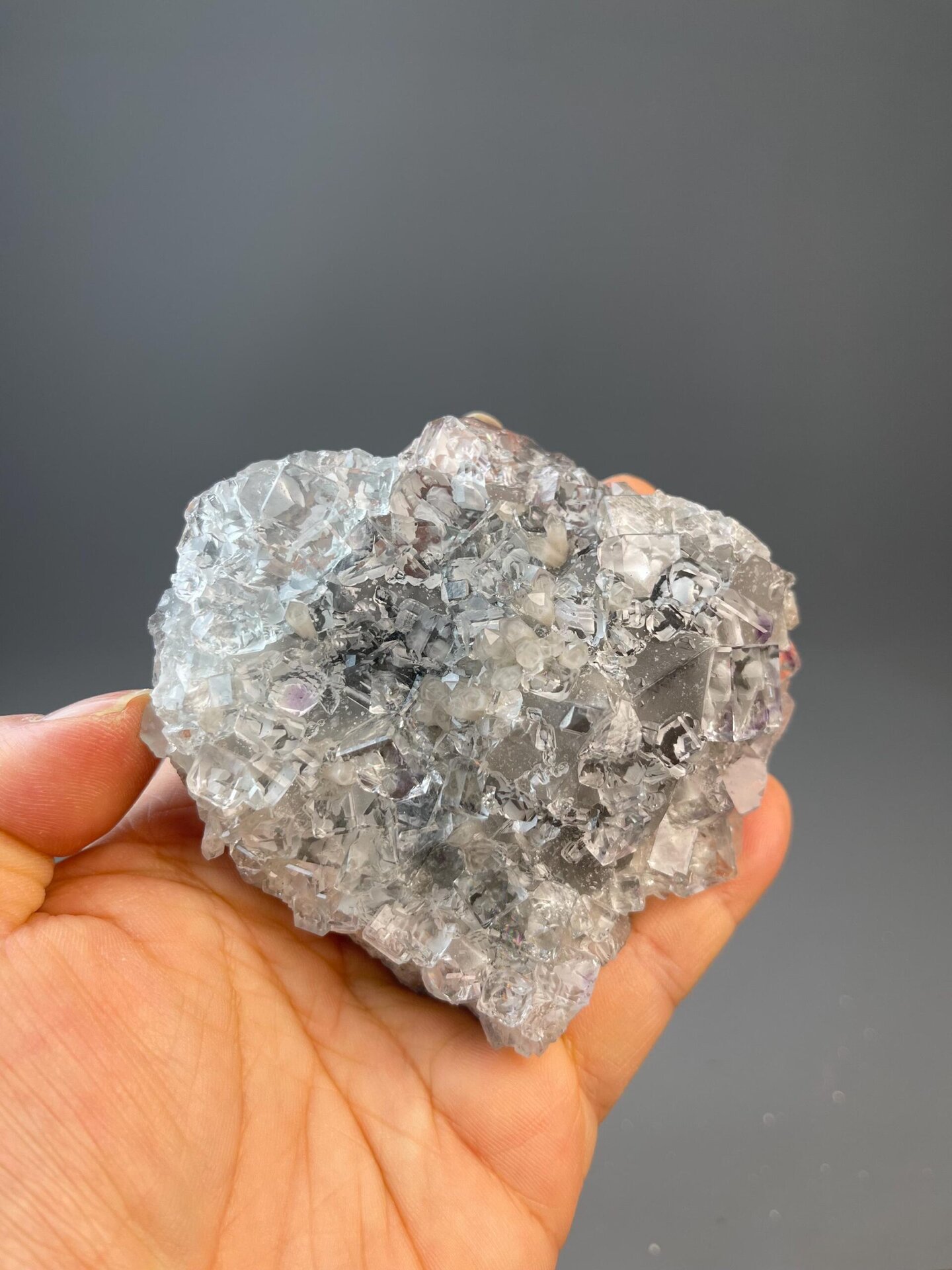 Diamond-clear fluorite cluster with floating cubic crystals