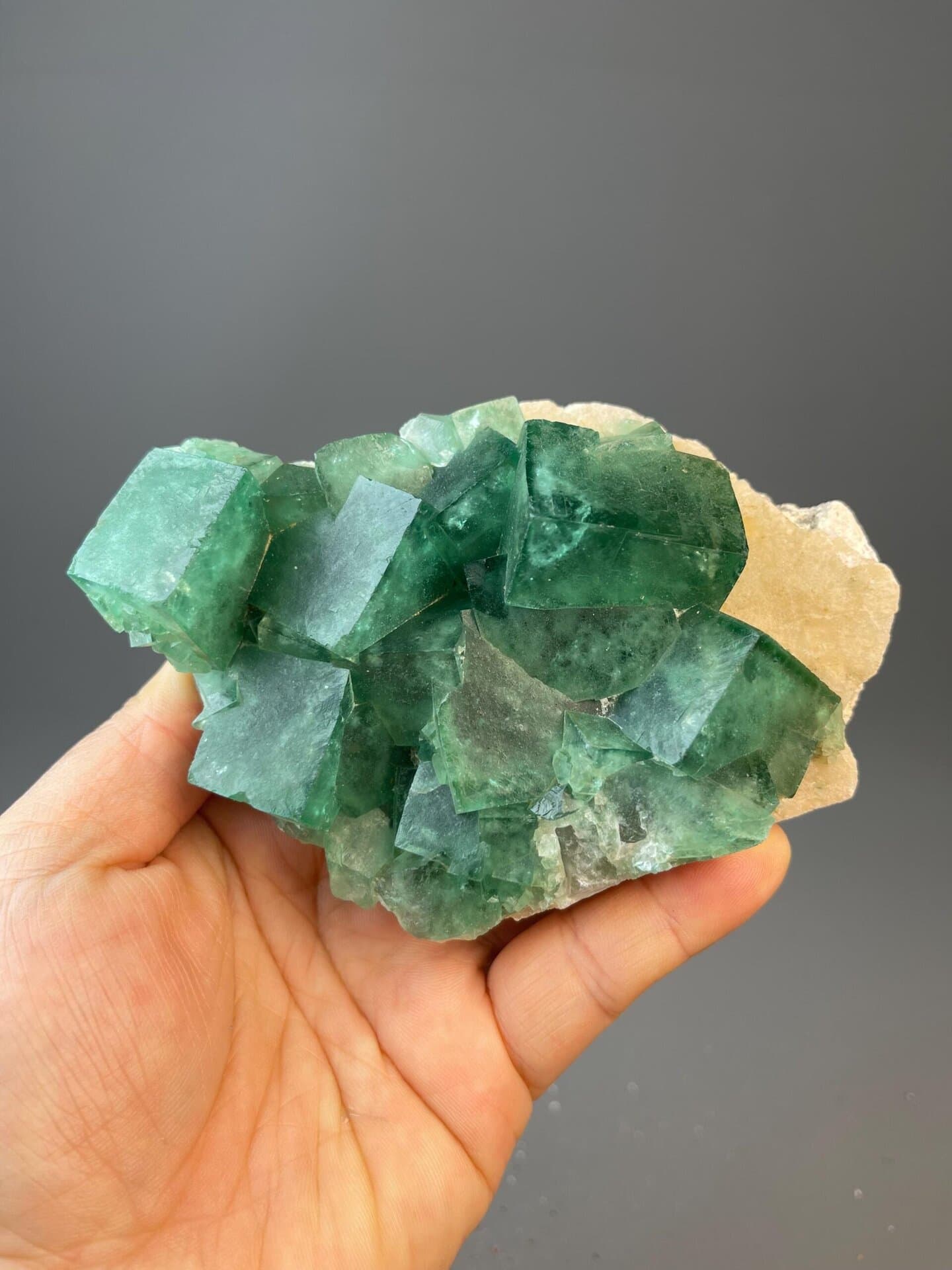 Green fluorite crystal specimen from Madagascar on golden matrix
