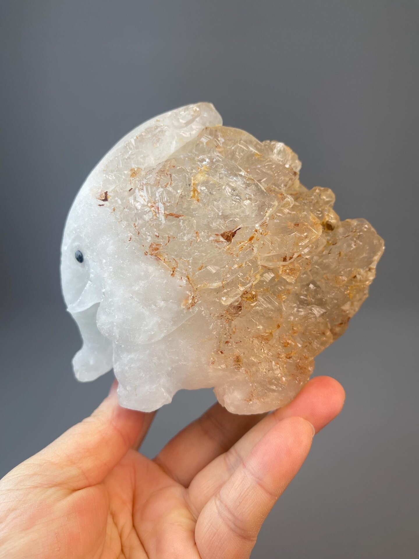 Artisan-carved white quartz elephant with natural mineral texture