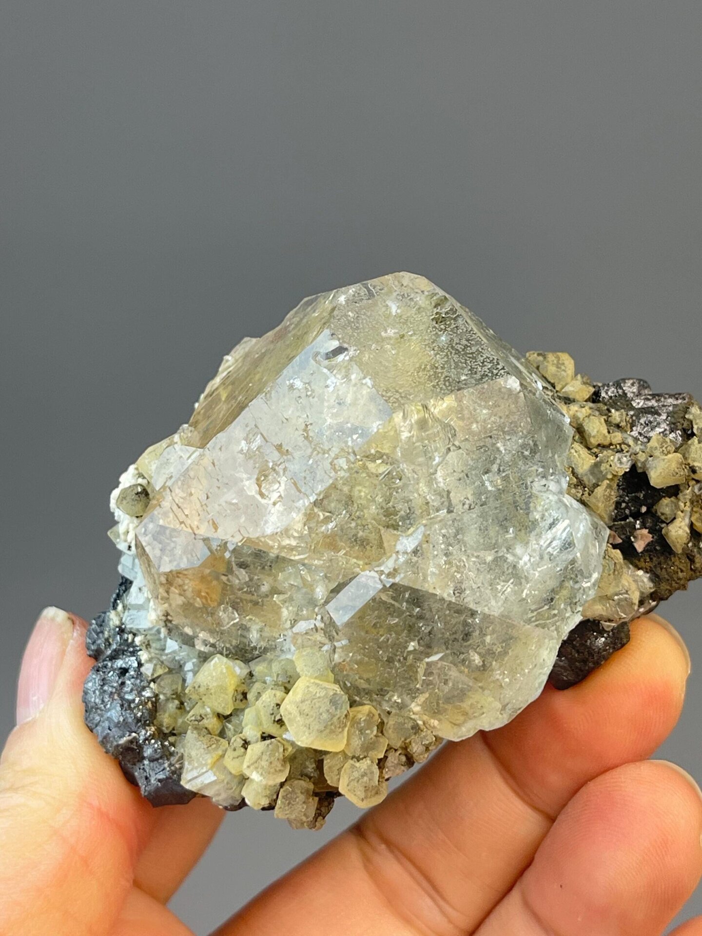 CaF₂ isometric white fluorite sphere with cassiterite mineral specks
