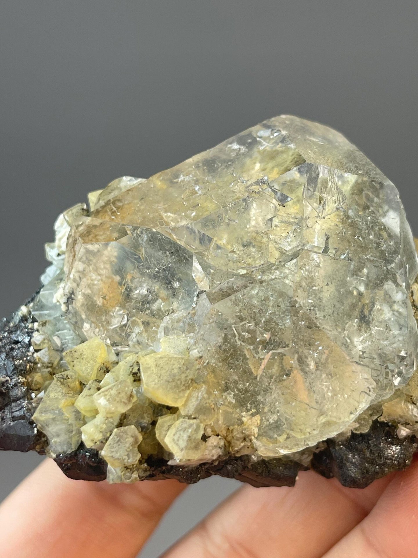 Spherical fluorite with cassiterite measuring 2.8×1.8×1.8 inches