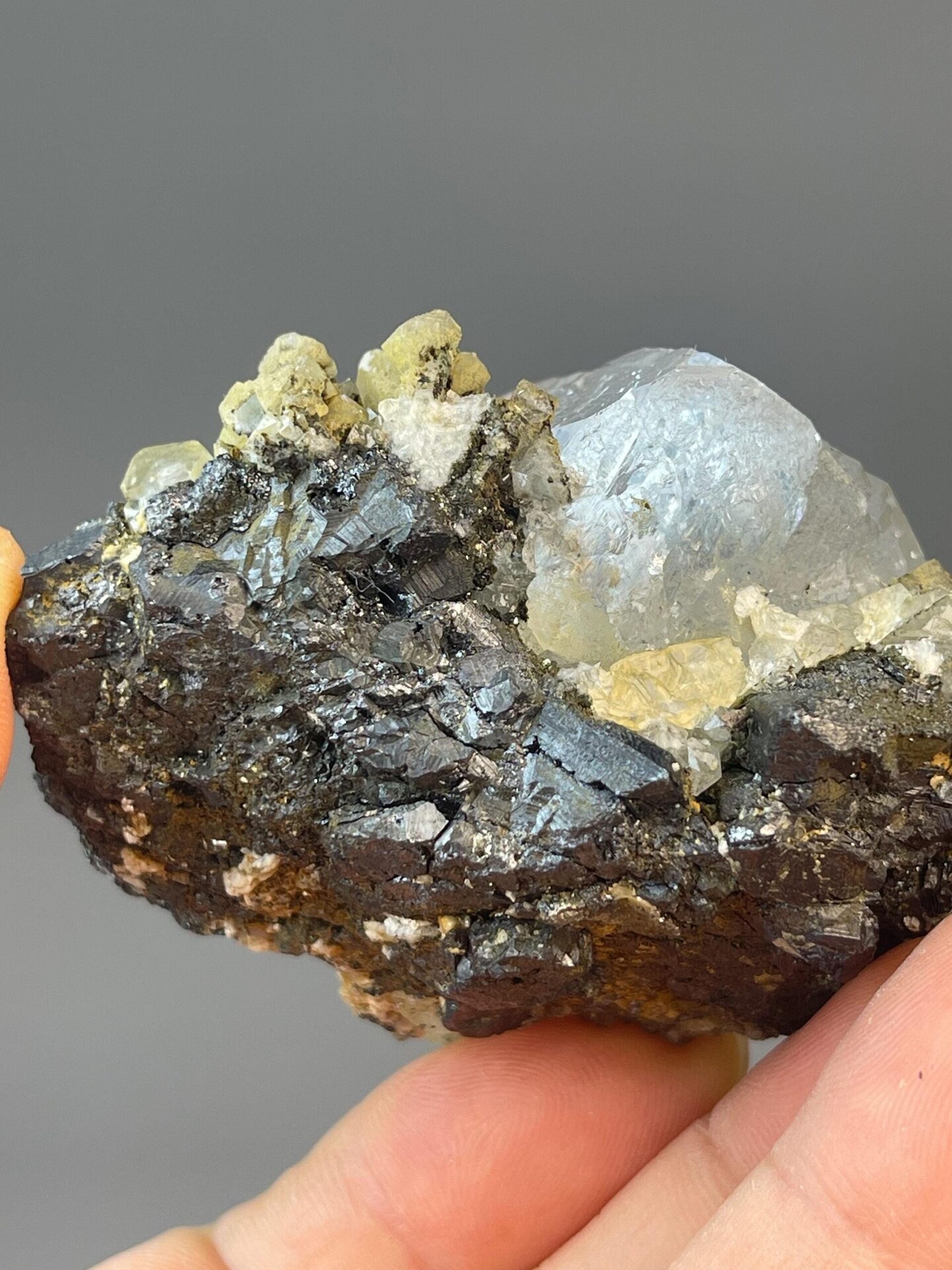 Translucent white fluorite in globular form with cassiterite