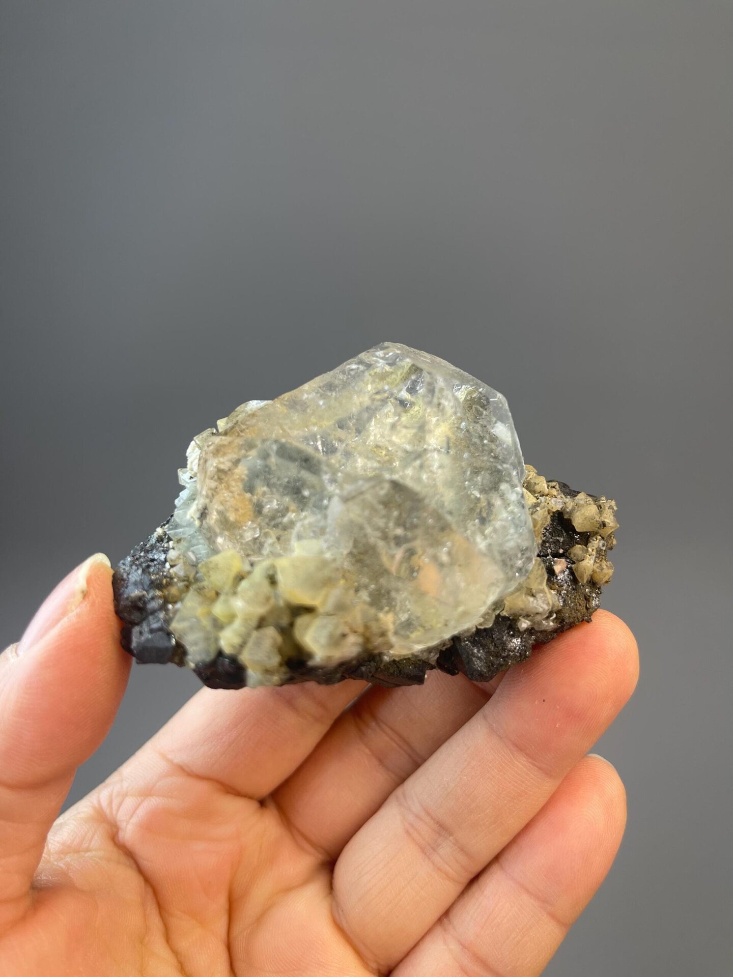 Frosty white fluorite globe with black cassiterite inclusions