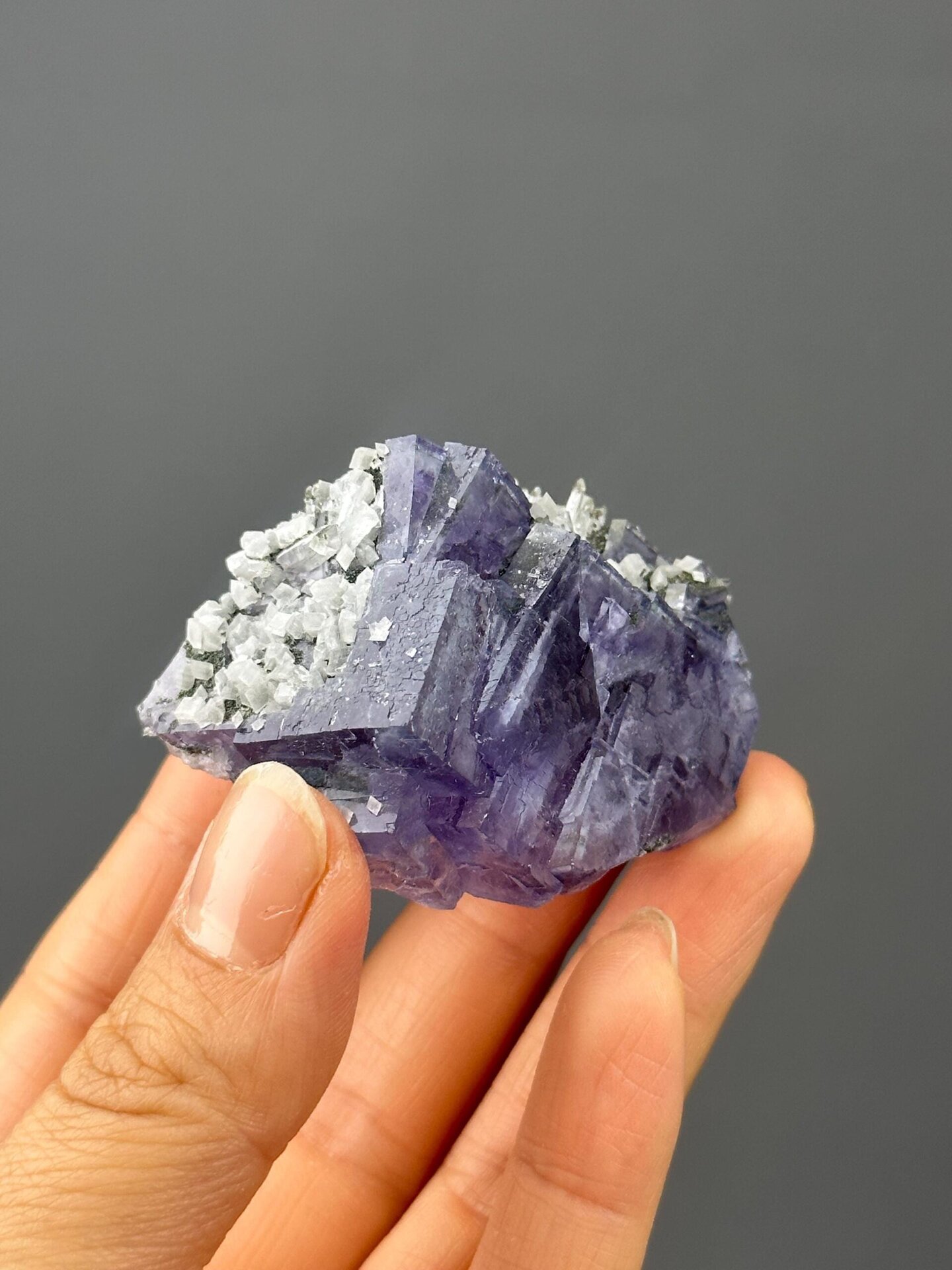 Front view of deep purple twinned fluorite with calcite