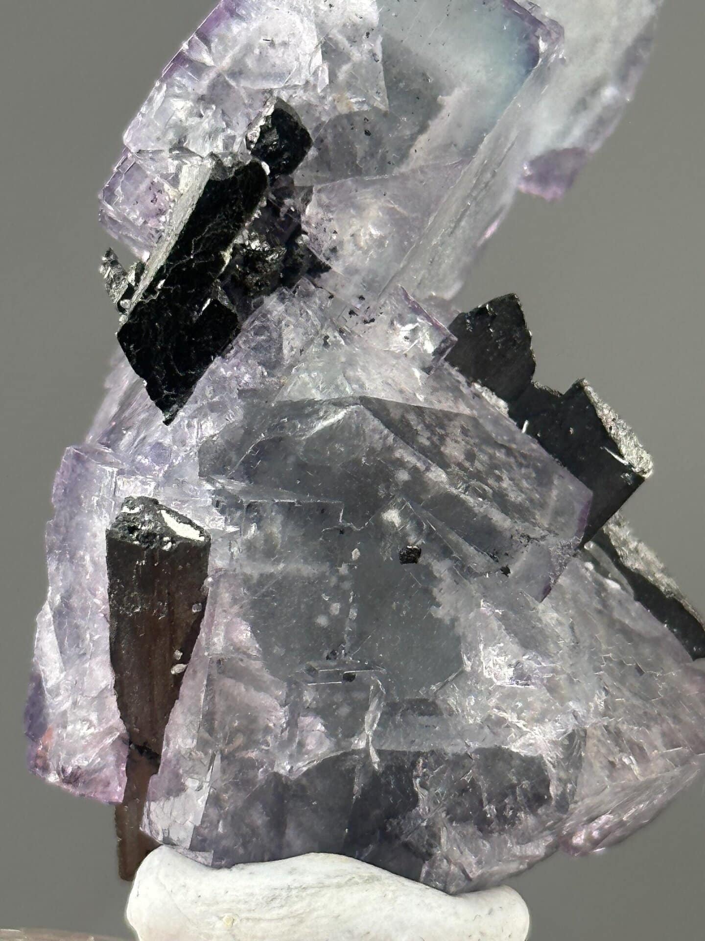 Back view of purple phantom fluorite with cassiterite