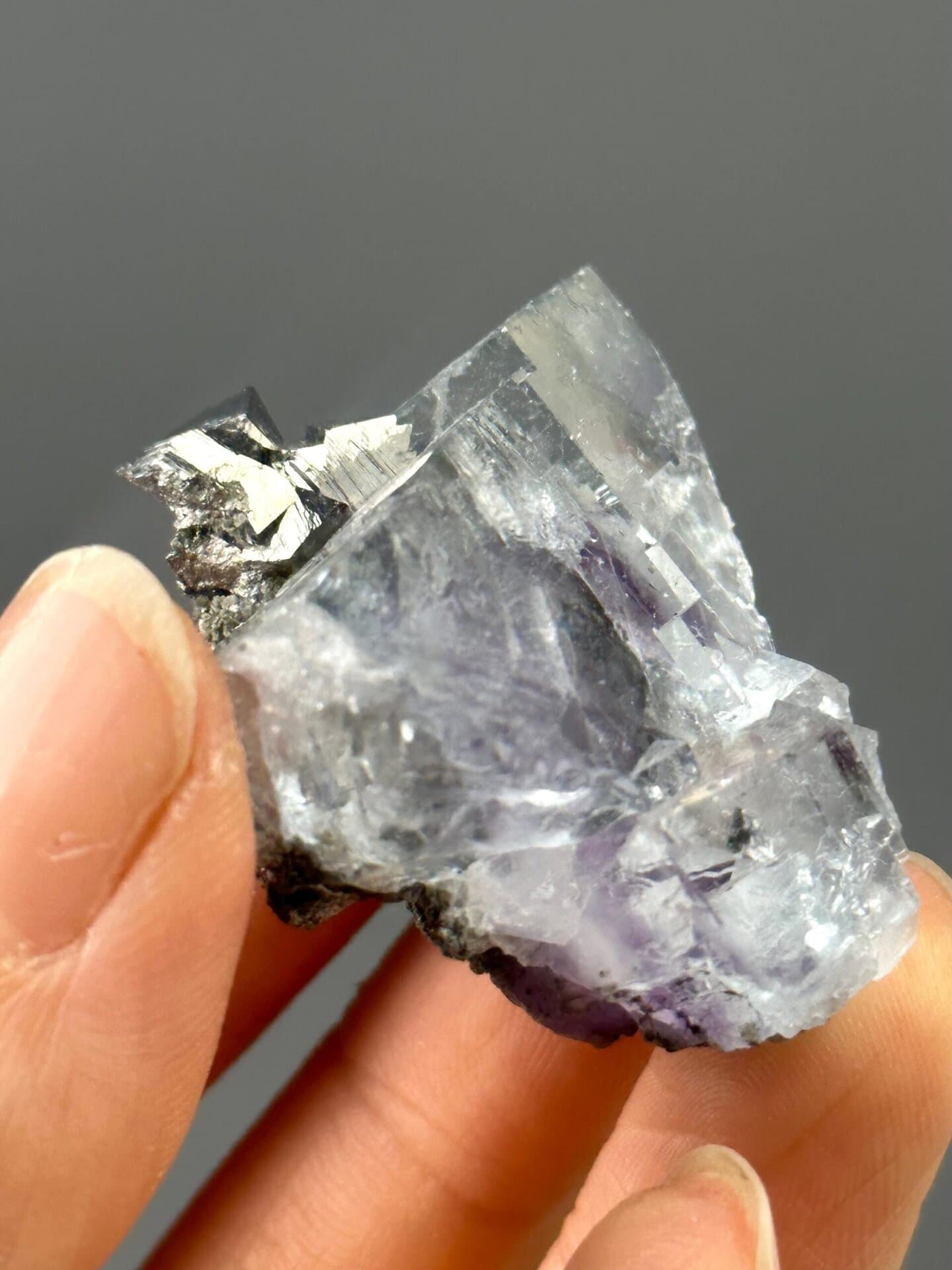 Angled view of purple fluorite with golden pyrite