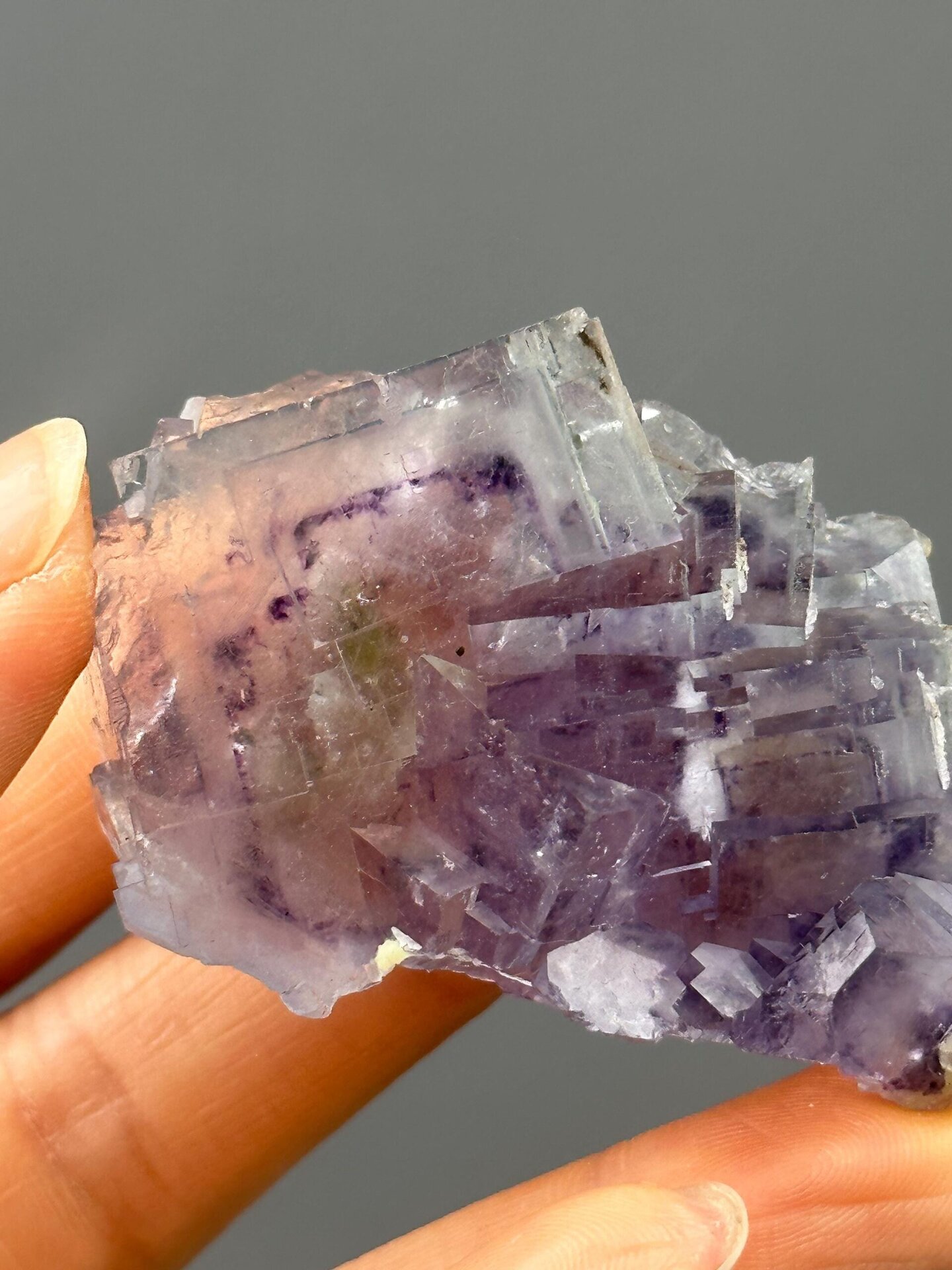 Angled view showing rainbow sheen on purple fluorite