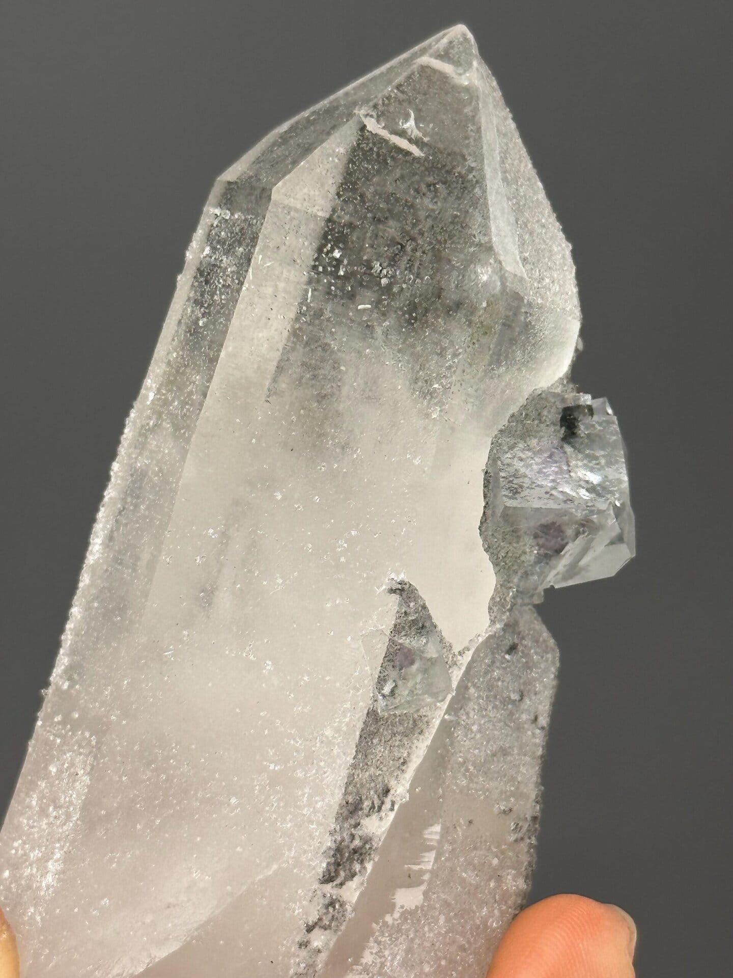 Angled view of raw green fluorite cluster on matrix