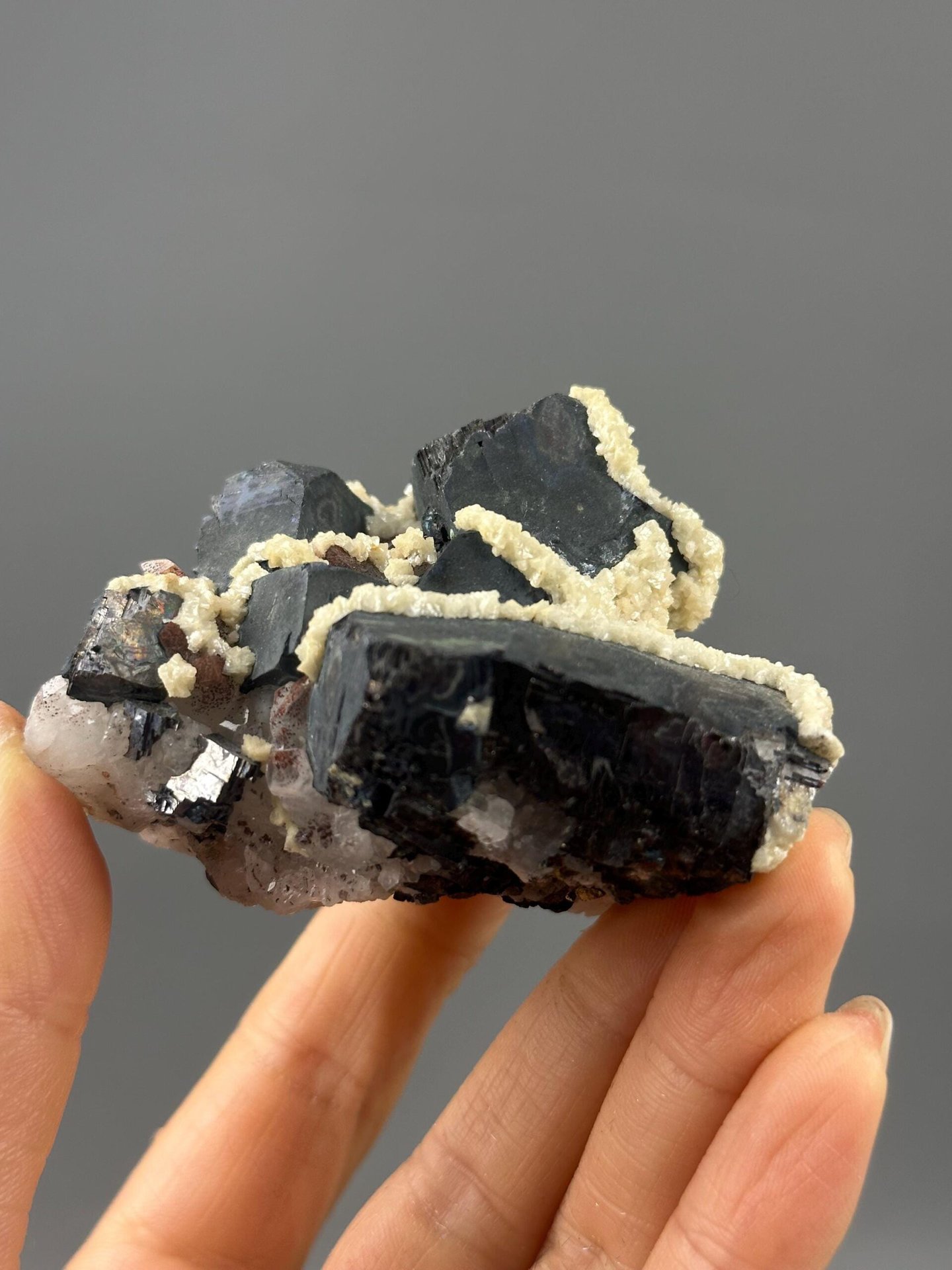 Detail of calcite inclusions on black iron ore surface