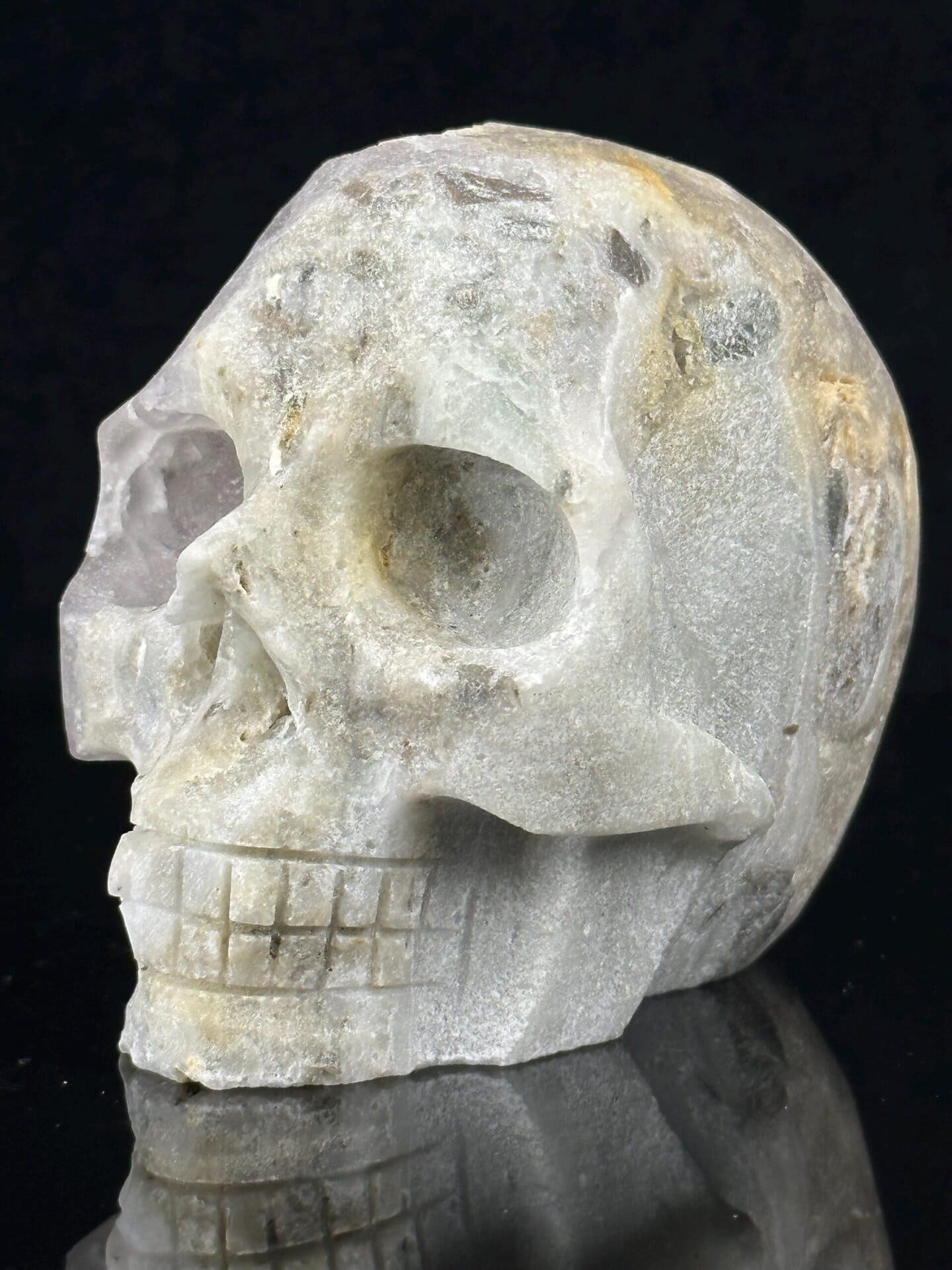 Large hand-carved quartz geode skull with druzy crystal interior