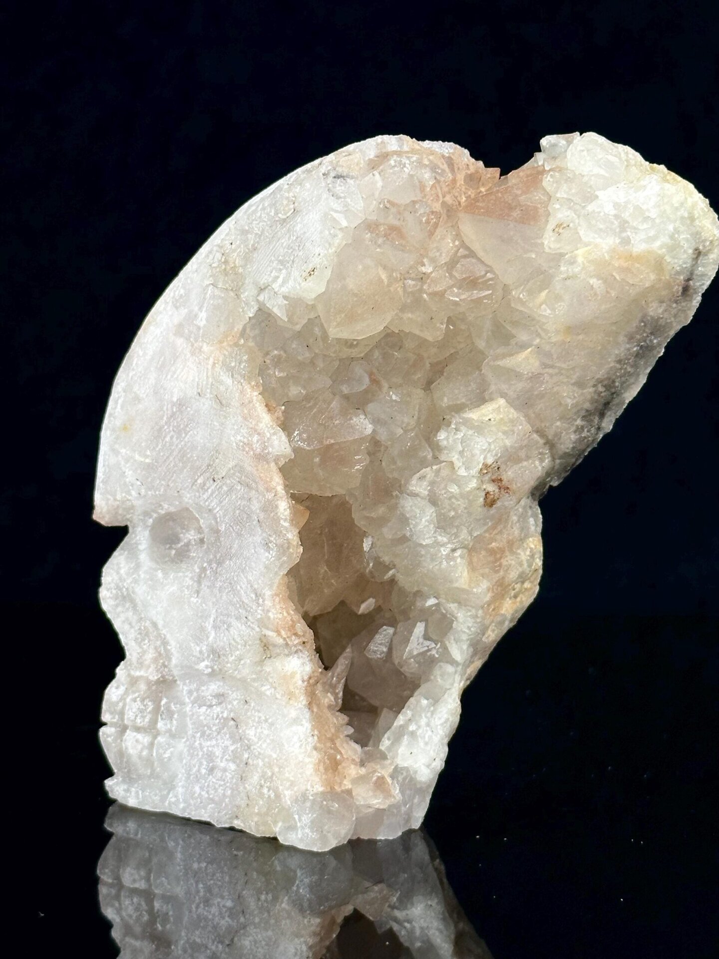 Angled view of quartz skull showing interior crystal sparkle