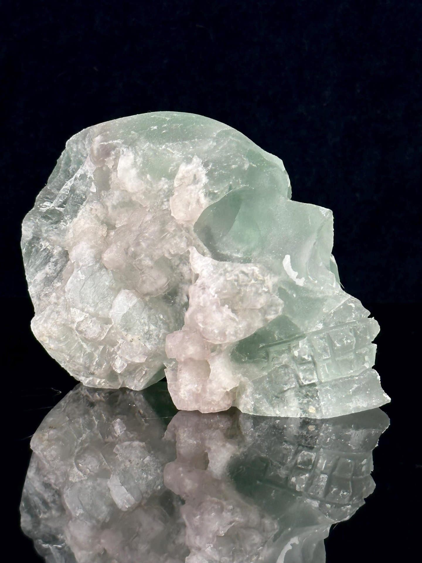 Side view of fluorite skull showing raw geode crystal interior