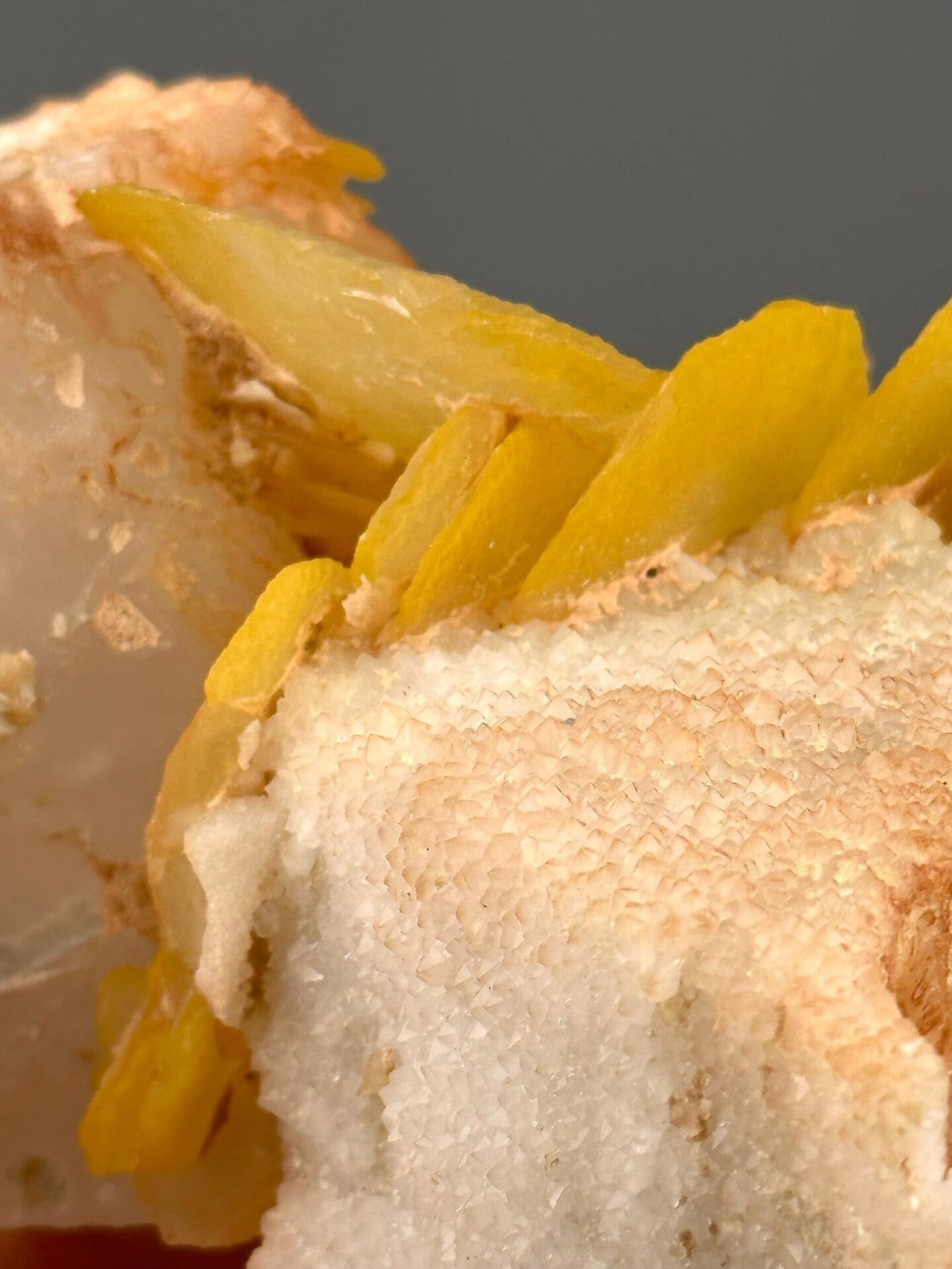 Close-up of yellow calcite surface showing botryoidal texture