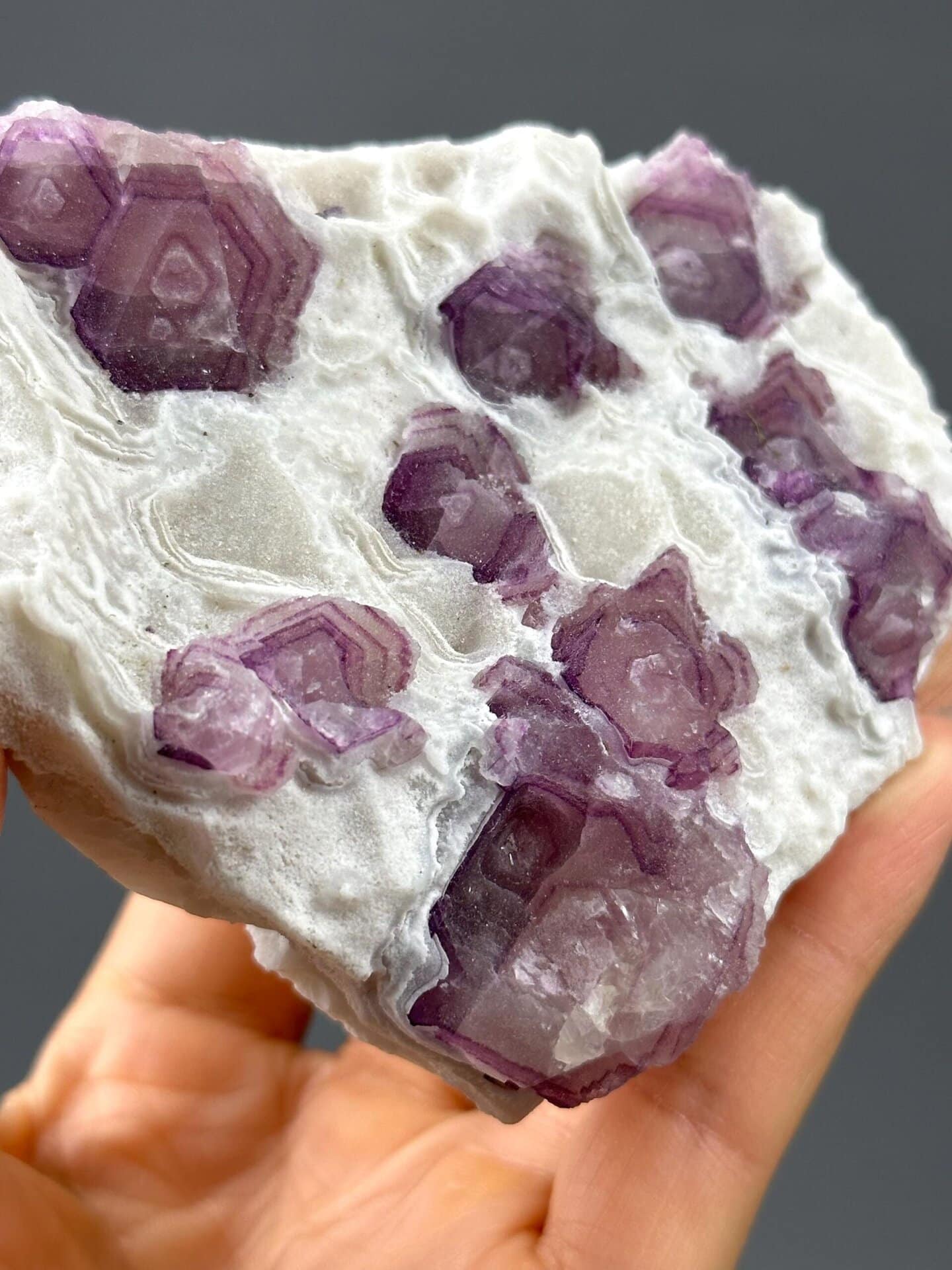 Angled view of purple banded fluorite lollipop form