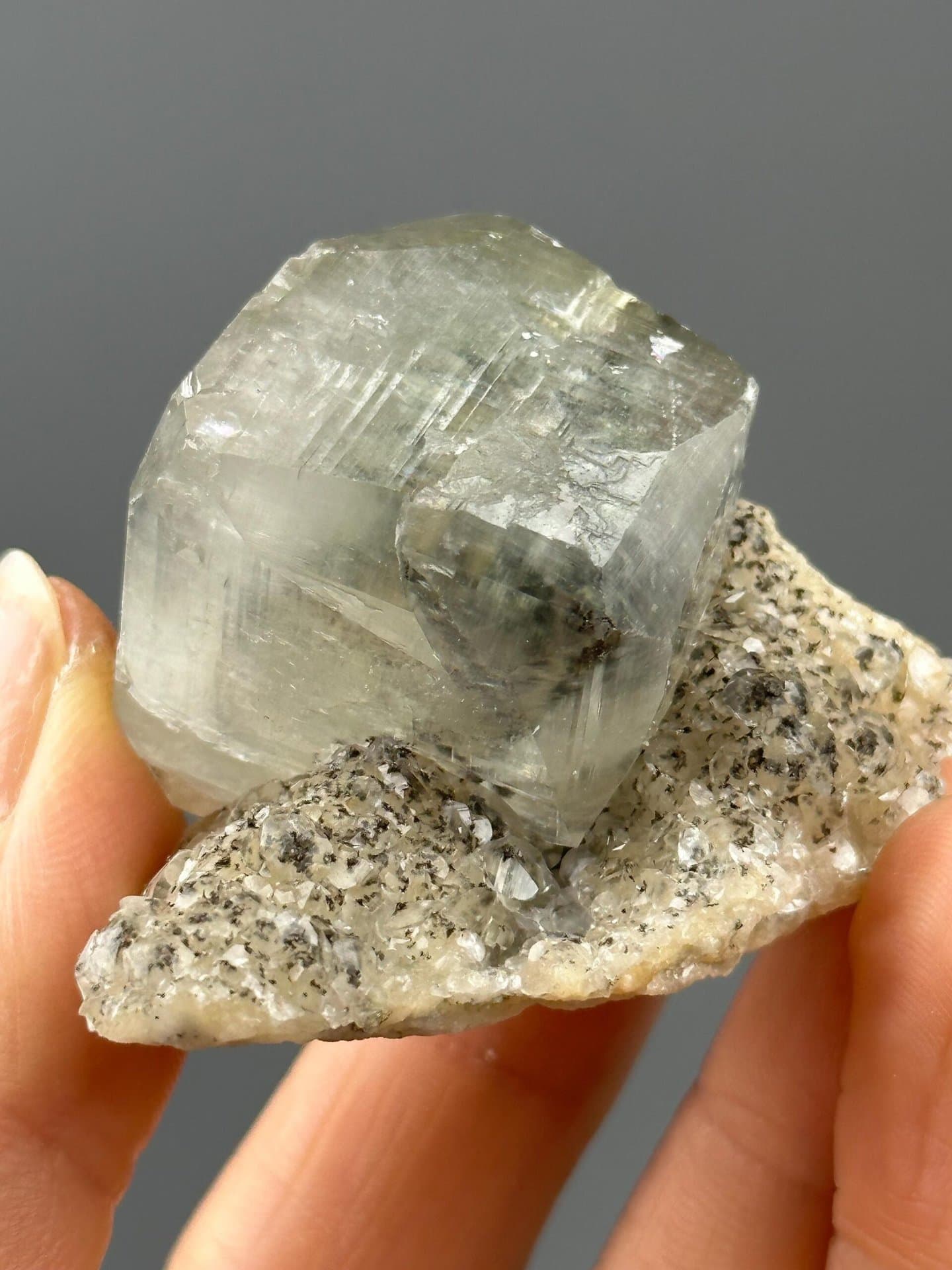 Angled view of lustrous calcite cluster on matrix