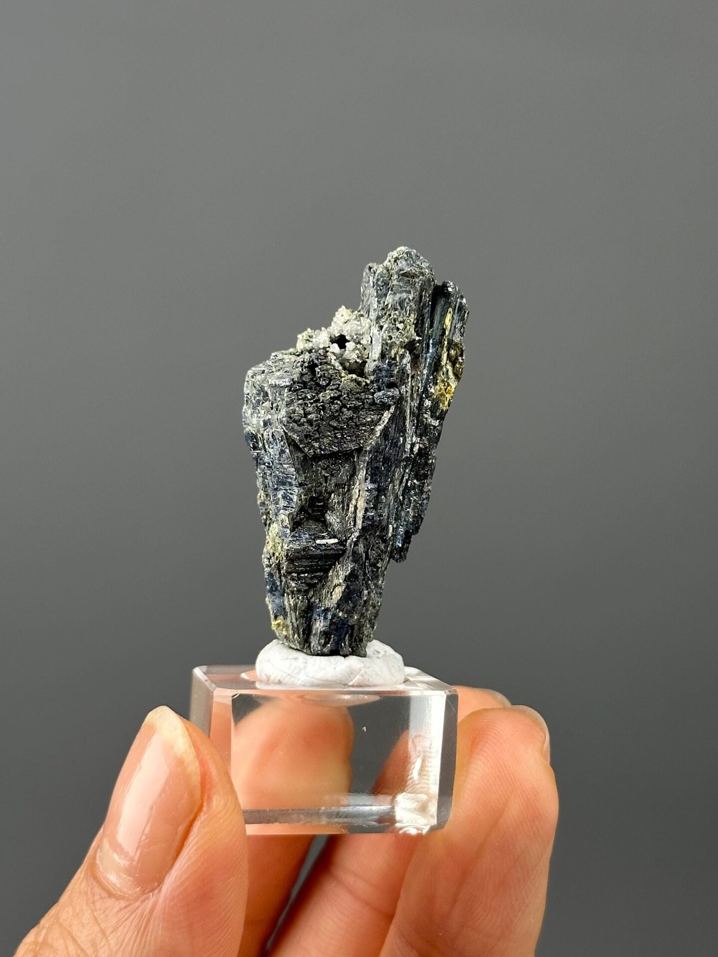 Close-up of stibnite surface showing iridescent metallic sheen