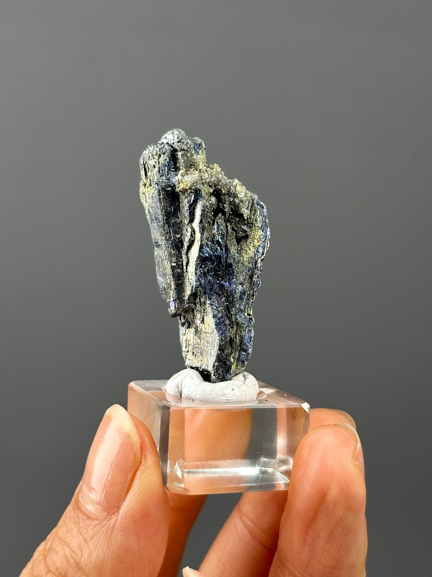Angled view highlighting iridescent sheen on stibnite