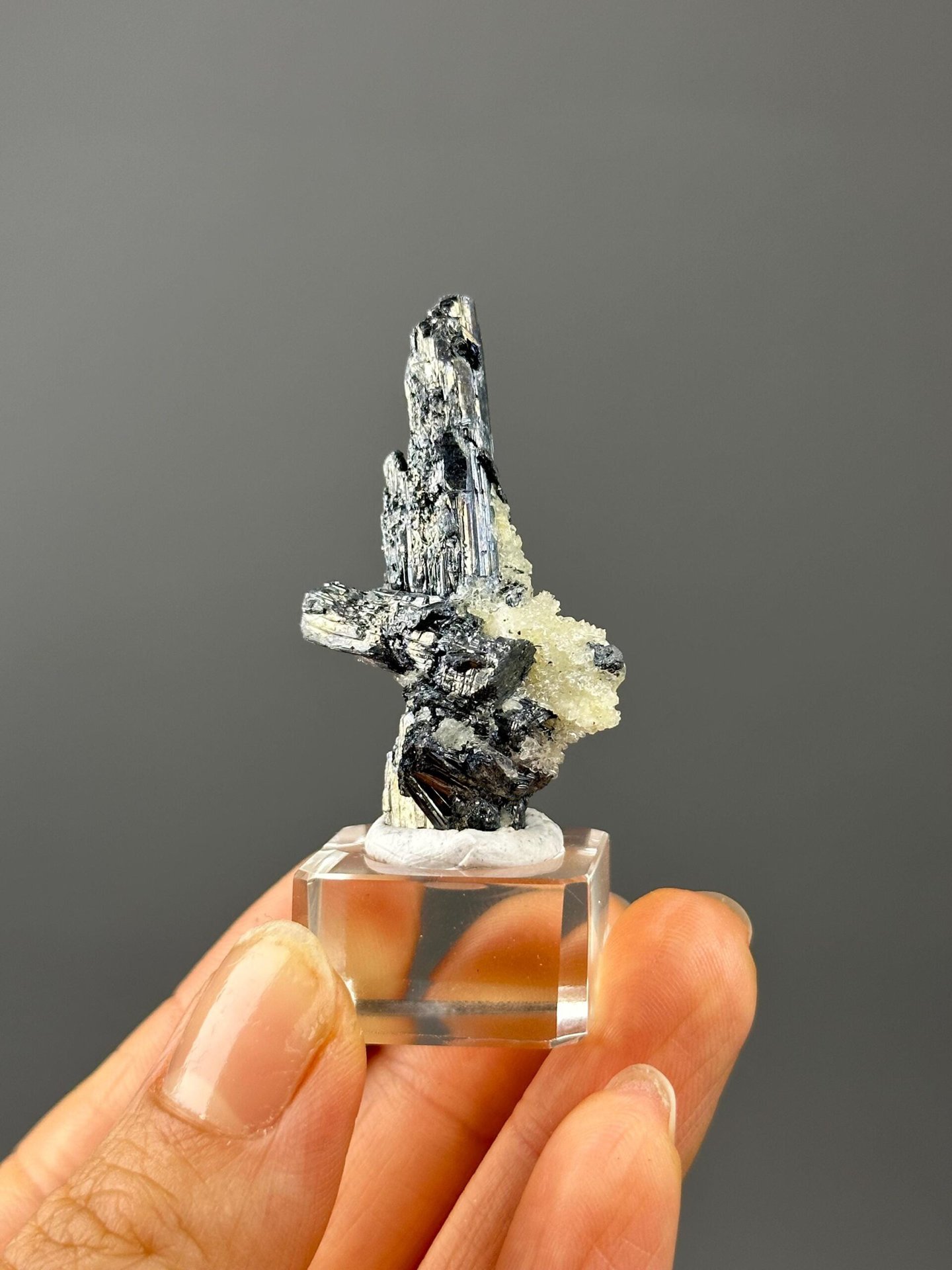 Angled view of stibnite on barite showing metallic luster