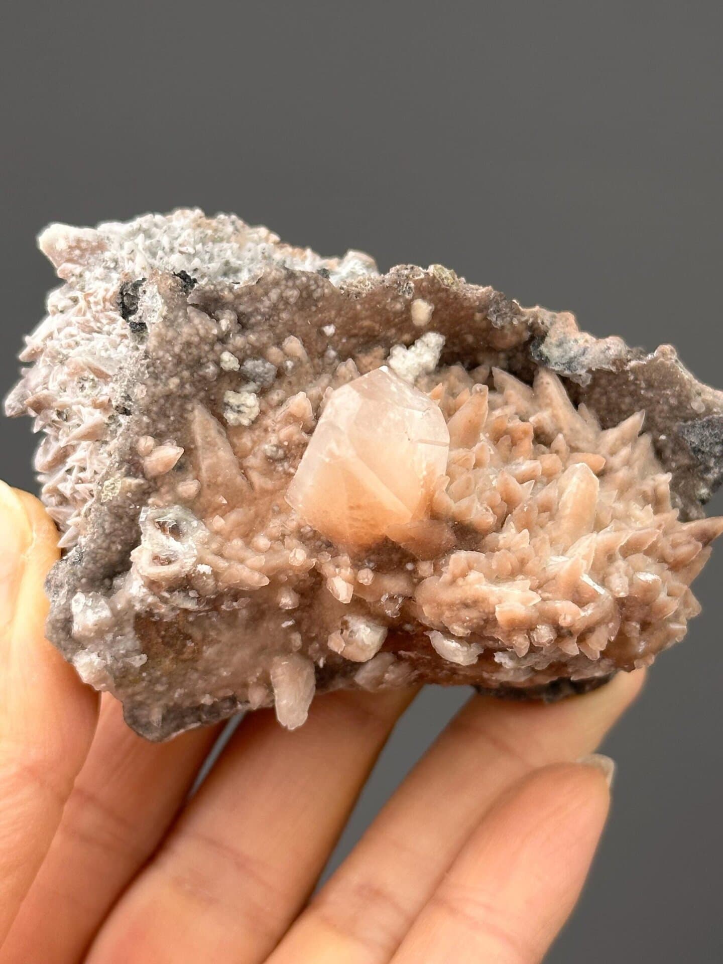 Front view of fluorescent calcite cluster, 3×2.2×2.3 in