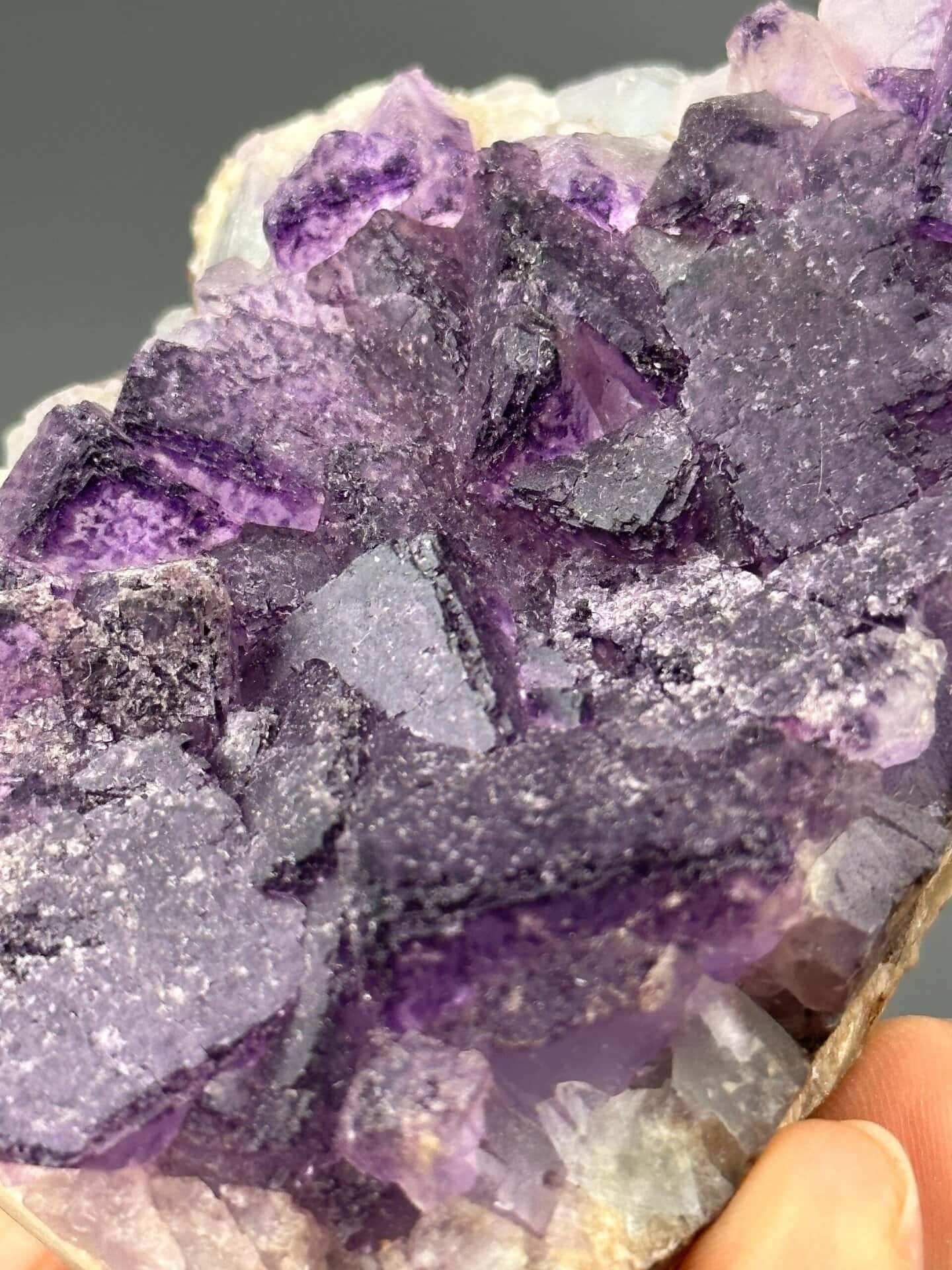 Angled view of purple fluorite cluster on quartz matrix