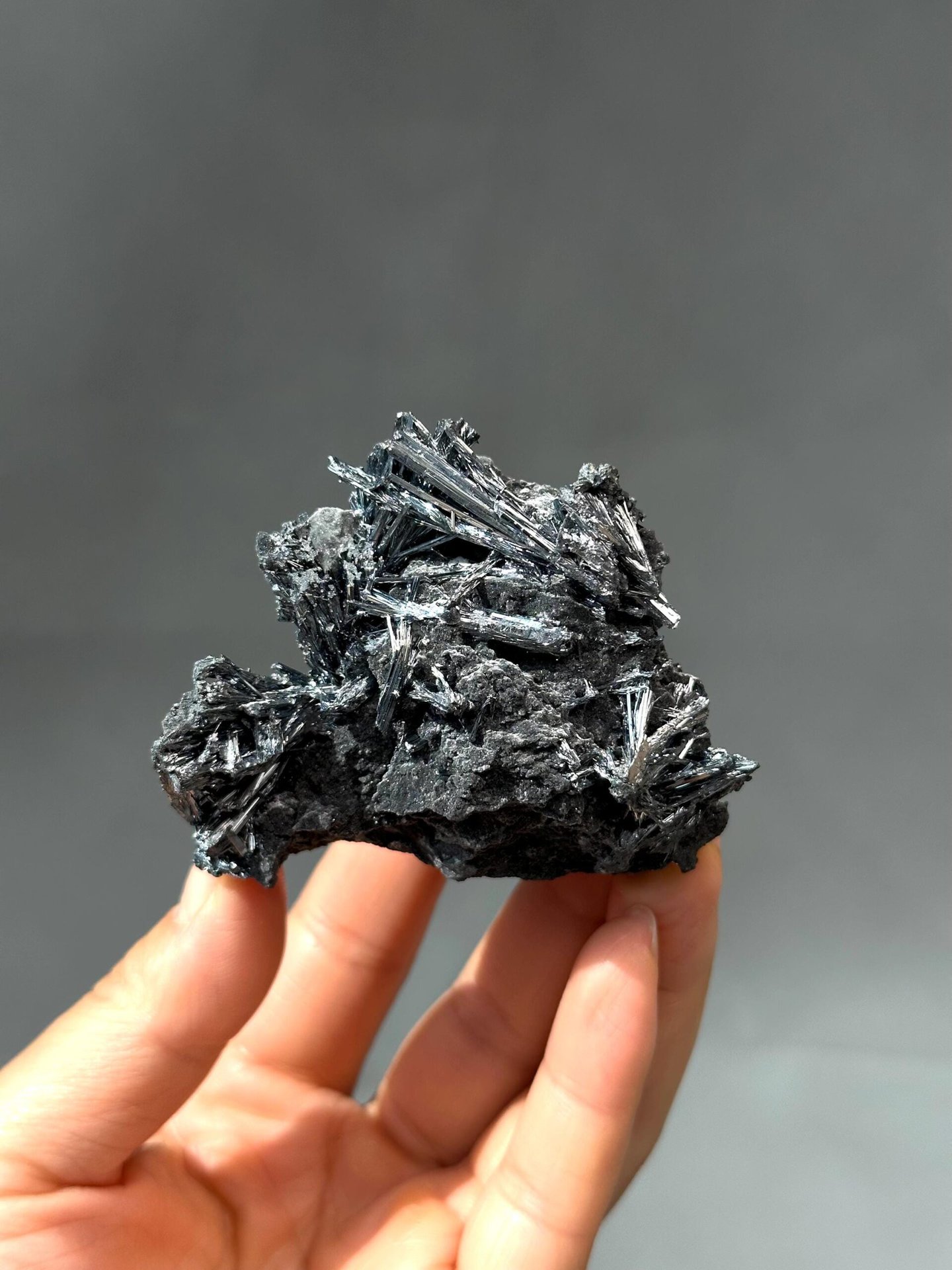 Close-up of long metallic stibnite blade crystals