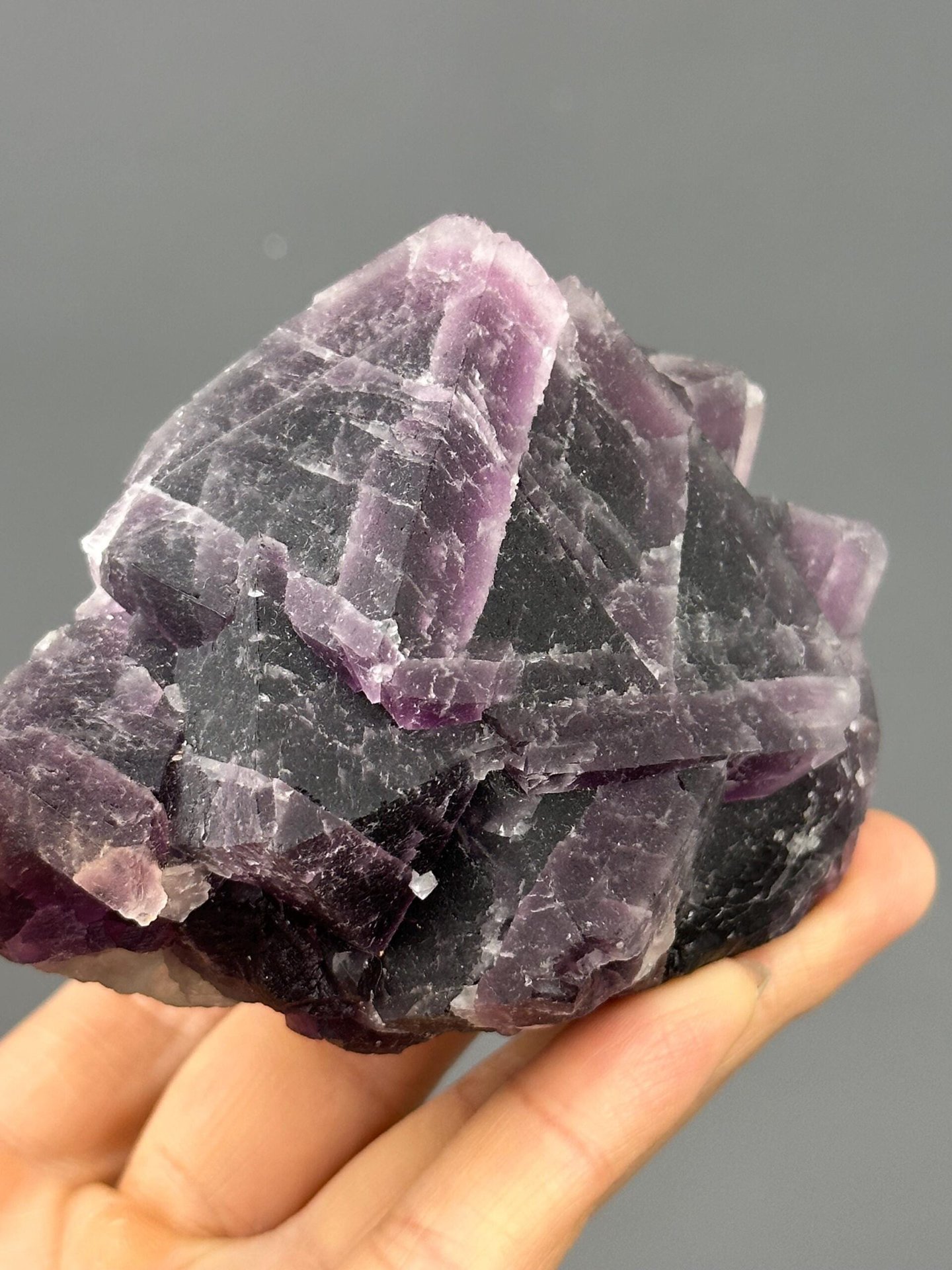 Angled view of triangular fluorite purple green core