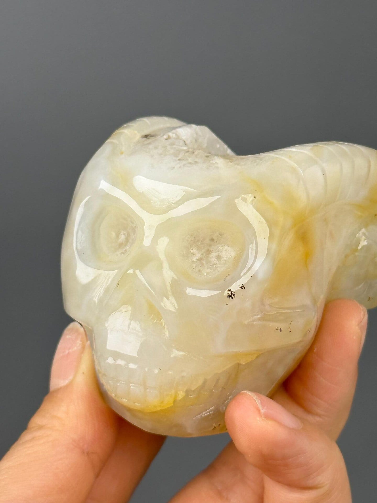 Carved agate skull with ruler for scale reference