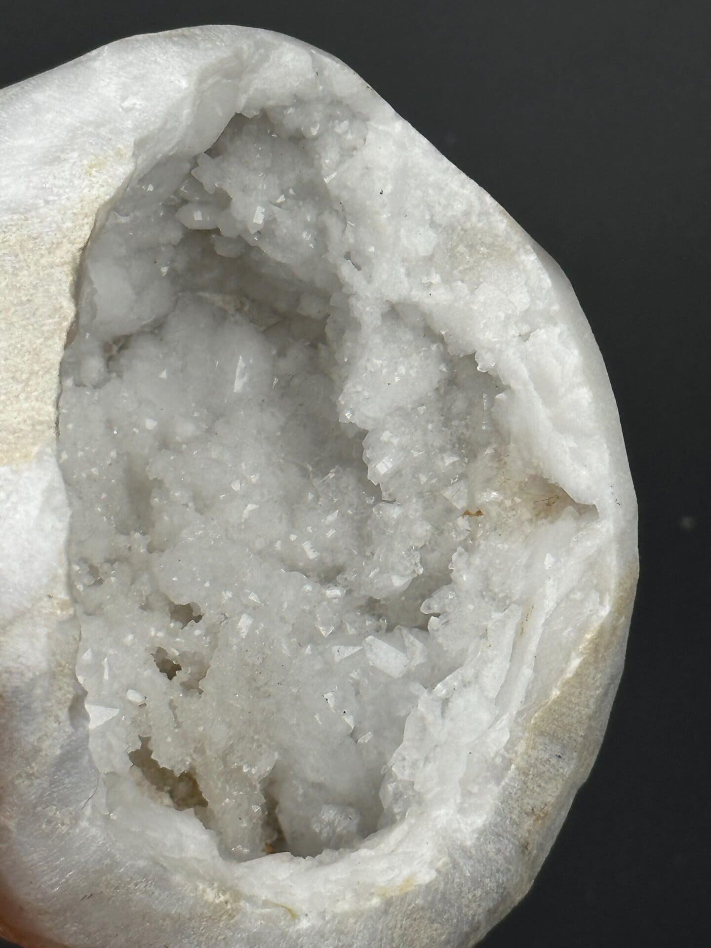 Rough exterior of large quartz geode on gold mount