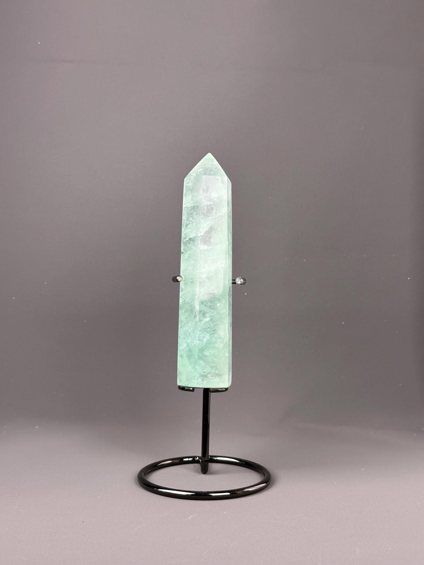 Side view of polished green fluorite obelisk tower