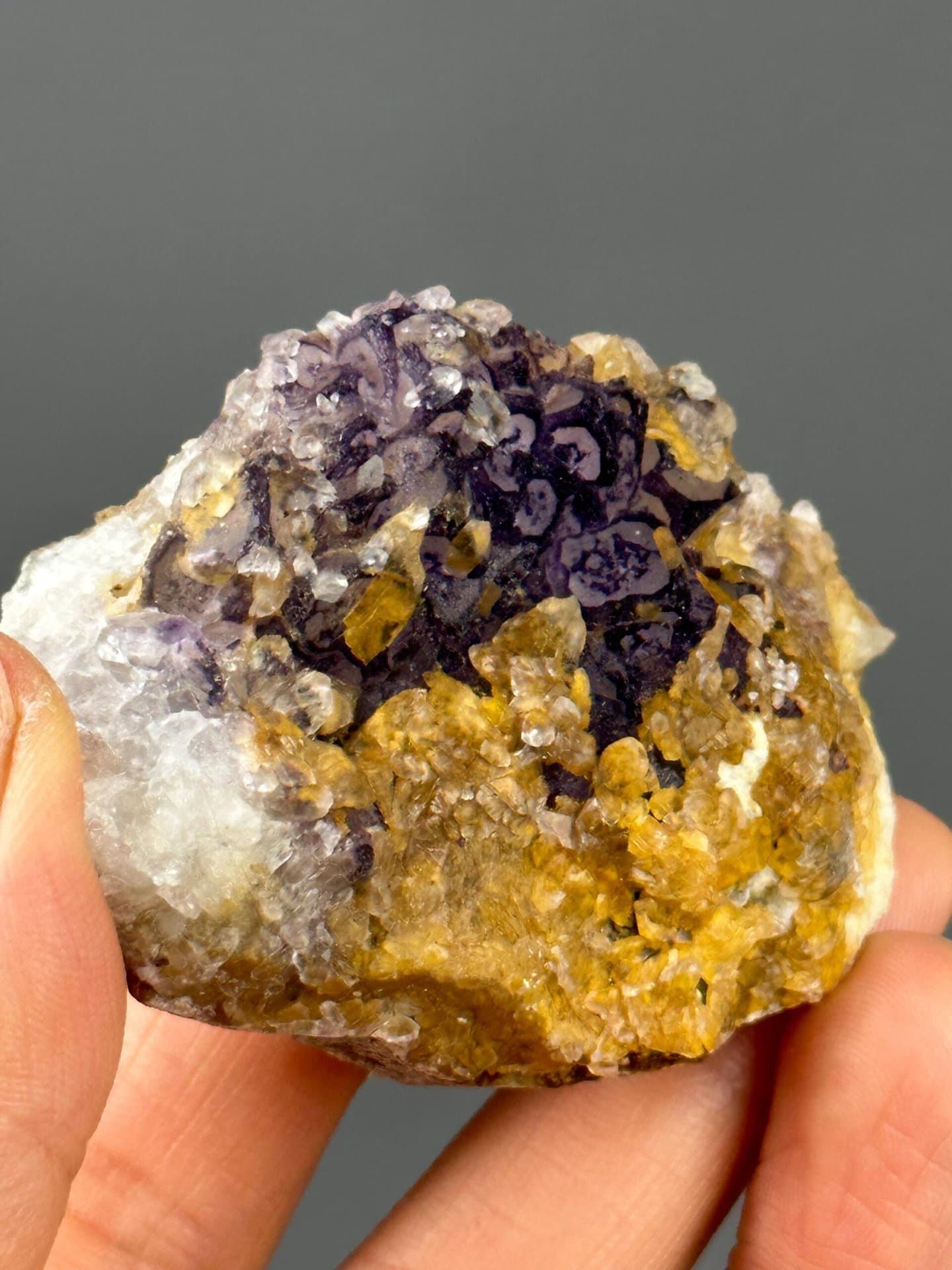 Purple fluorite cube faces with golden calcite accents