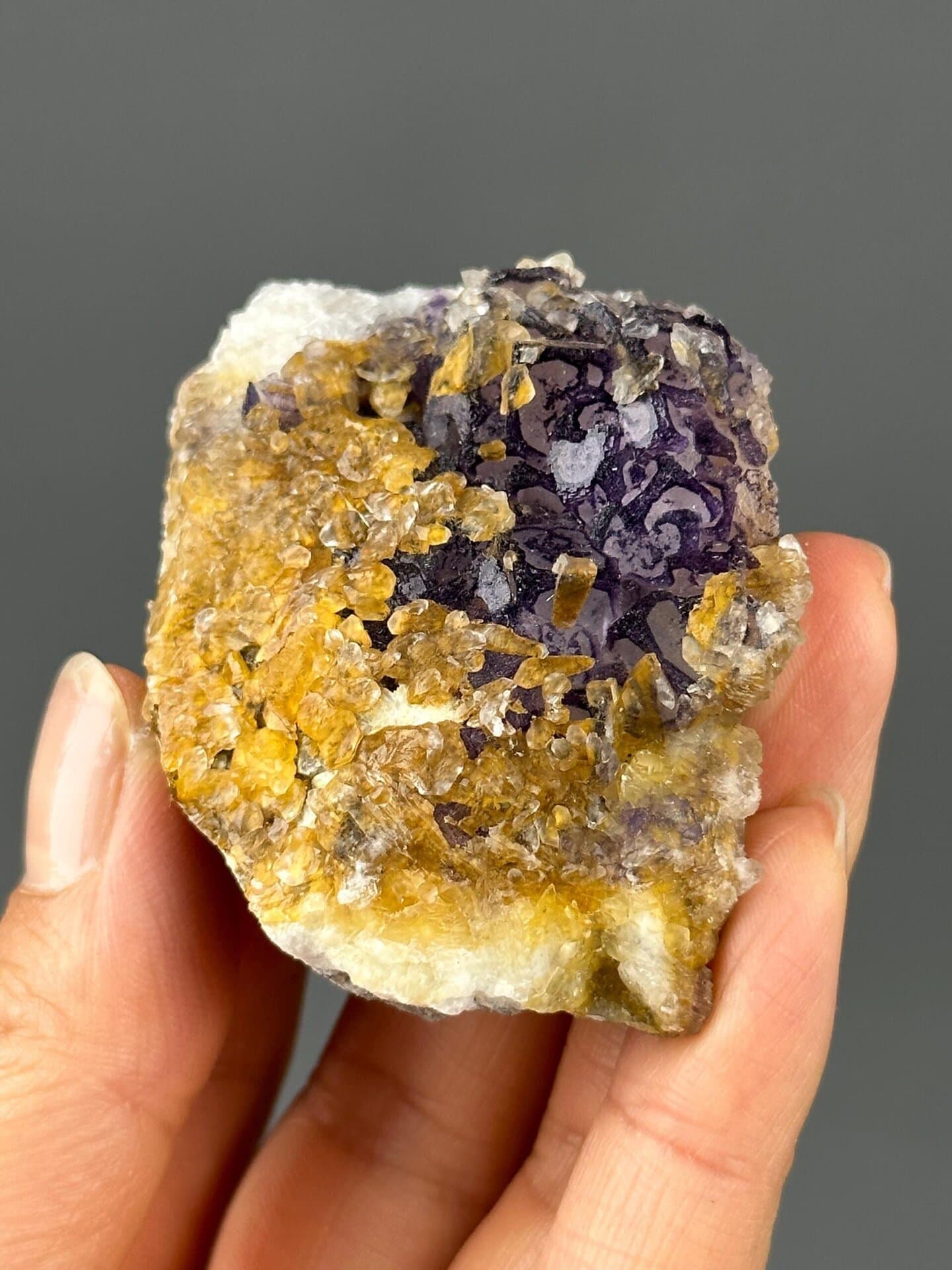 Vitreous luster on purple fluorite and gold calcite