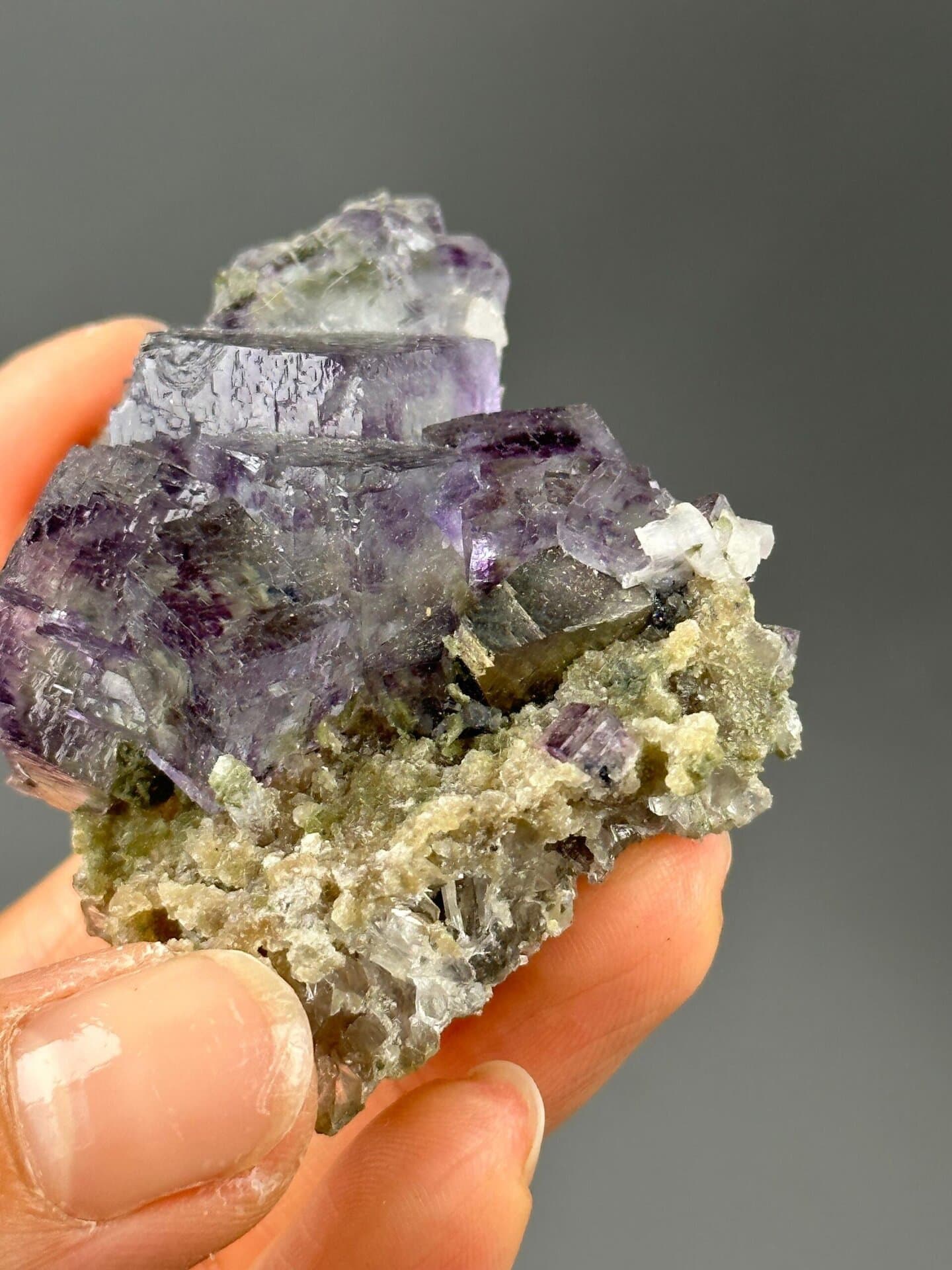 Vitreous luster on deep purple fluorite surfaces