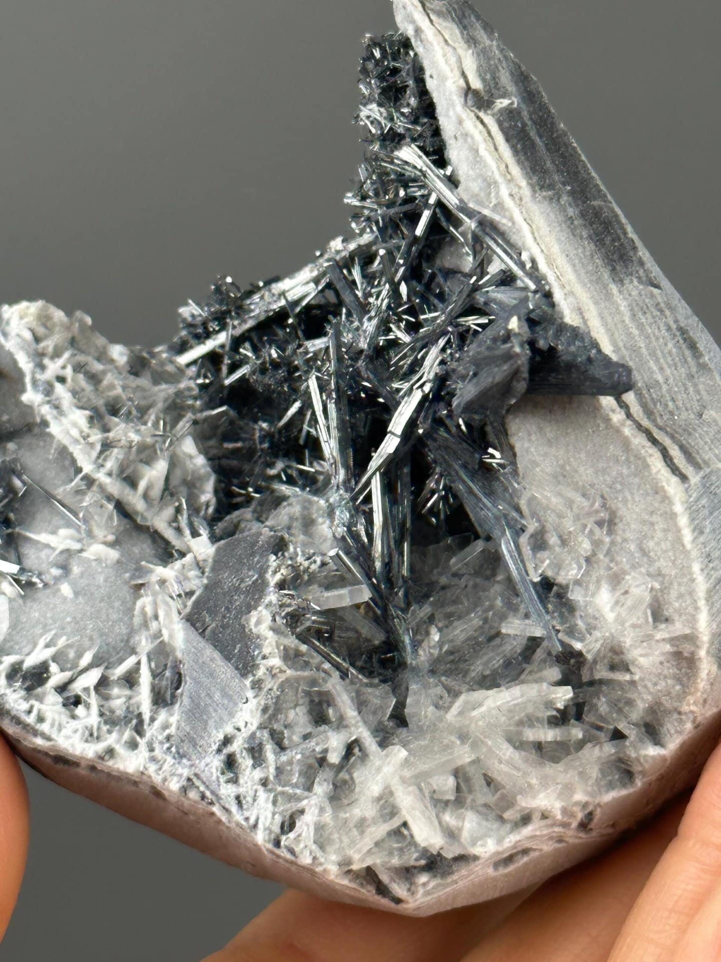 Metallic stibnite needles with white barite matrix