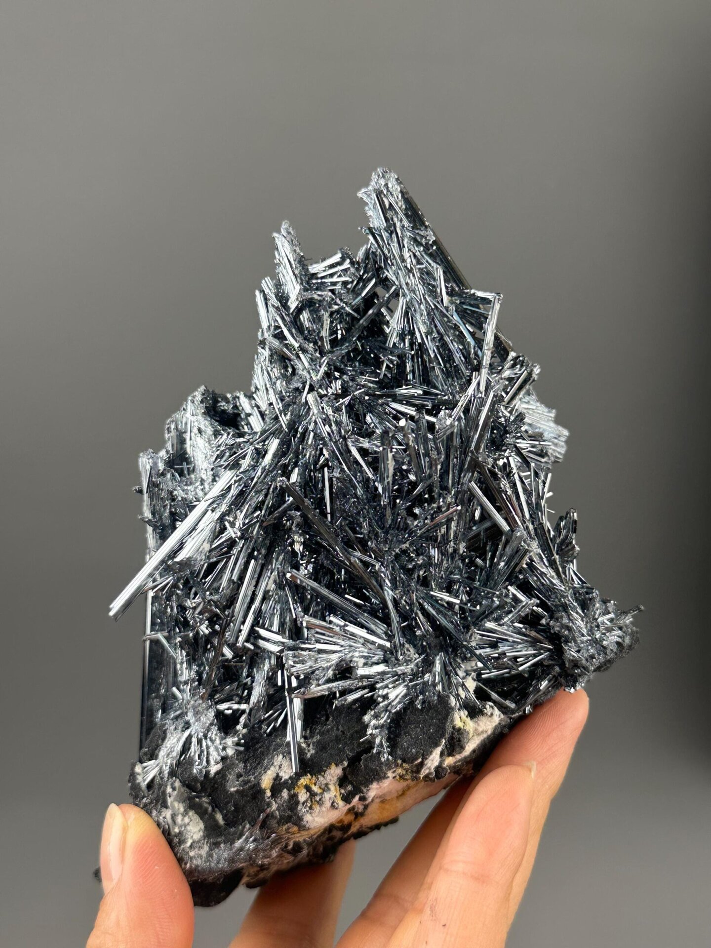 Close-up of elongated silvery stibnite crystal needles