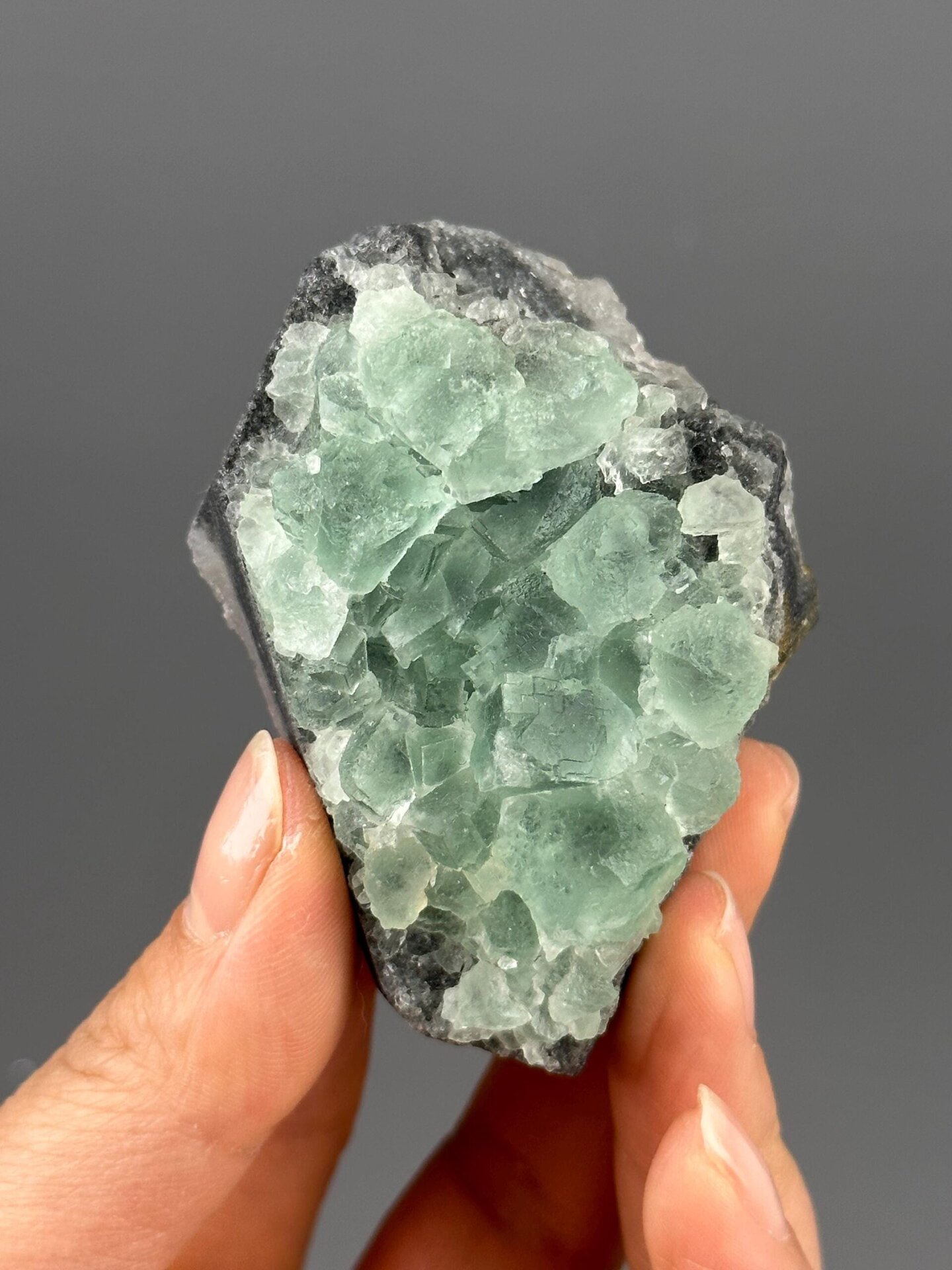 Green fluorite crystals against clear quartz close-up