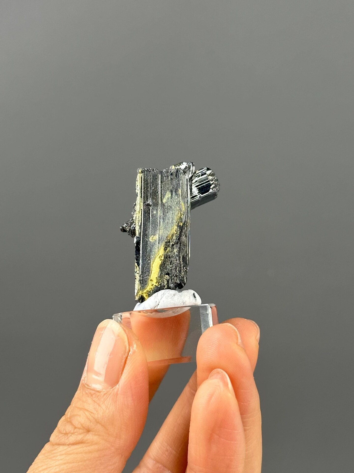 Hunan stibnite twin crystal under studio lighting