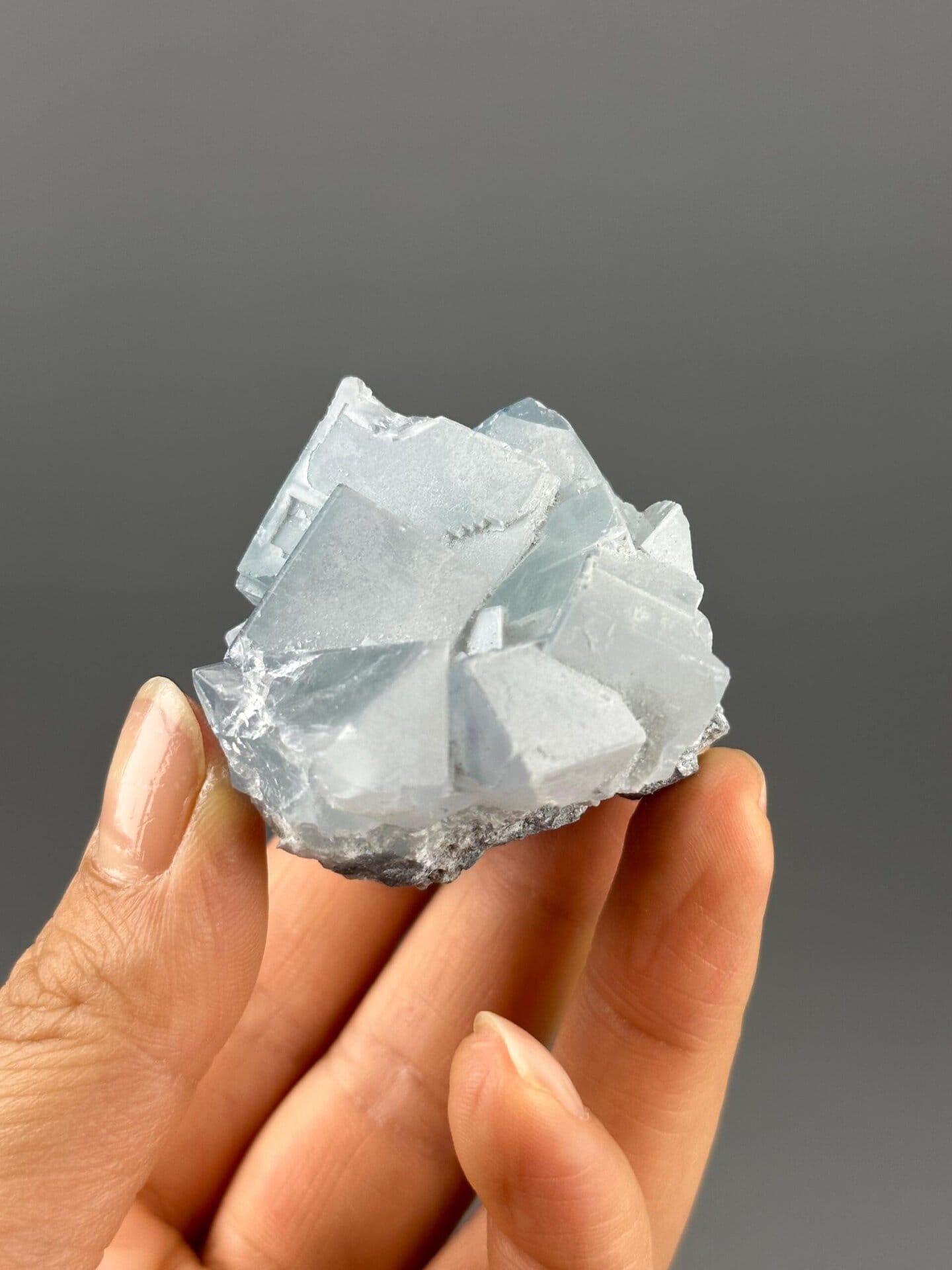 Side view of green-purple twin fluorite specimen