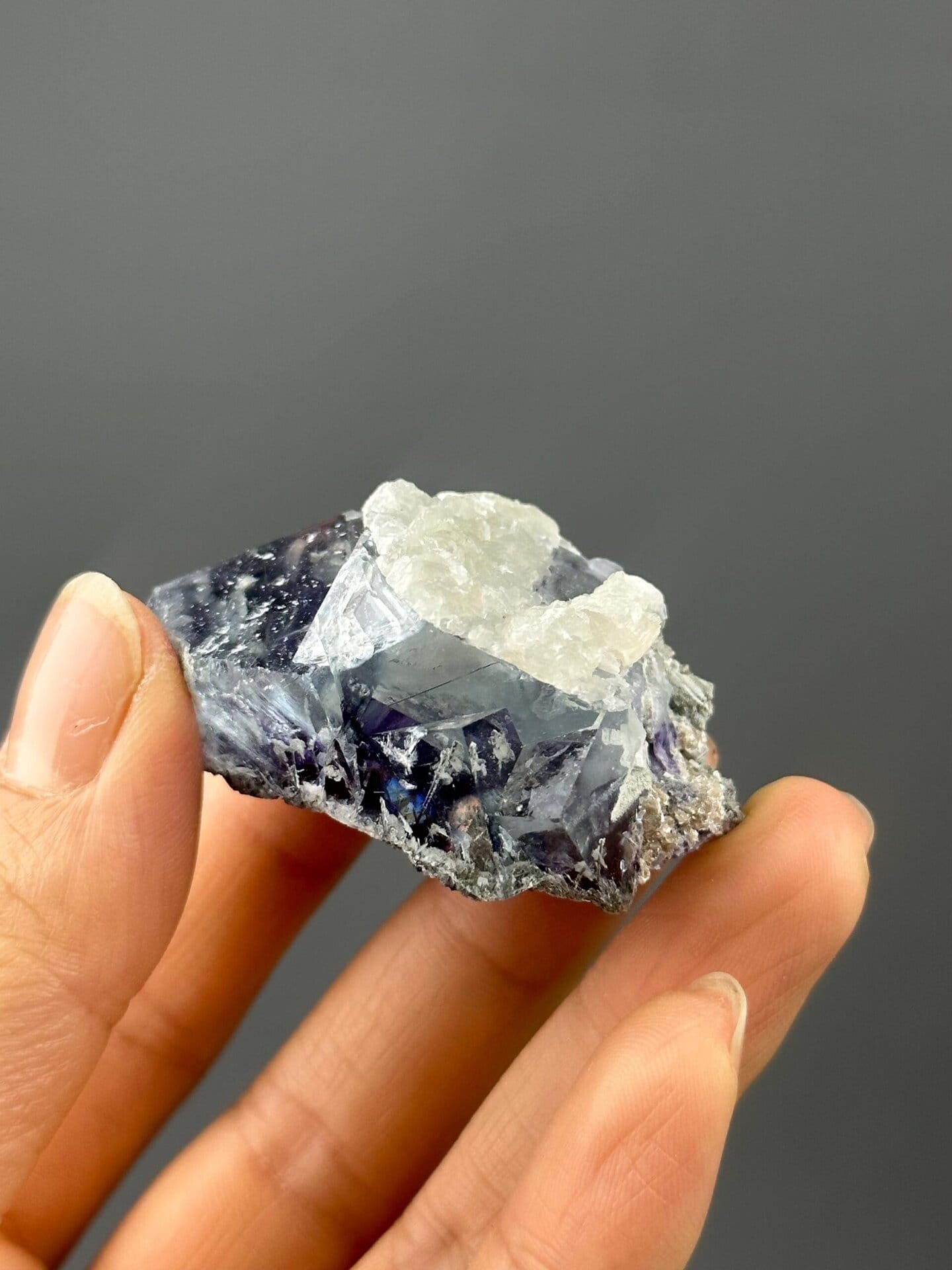 Front view of purple twinned fluorite showing calcite accents