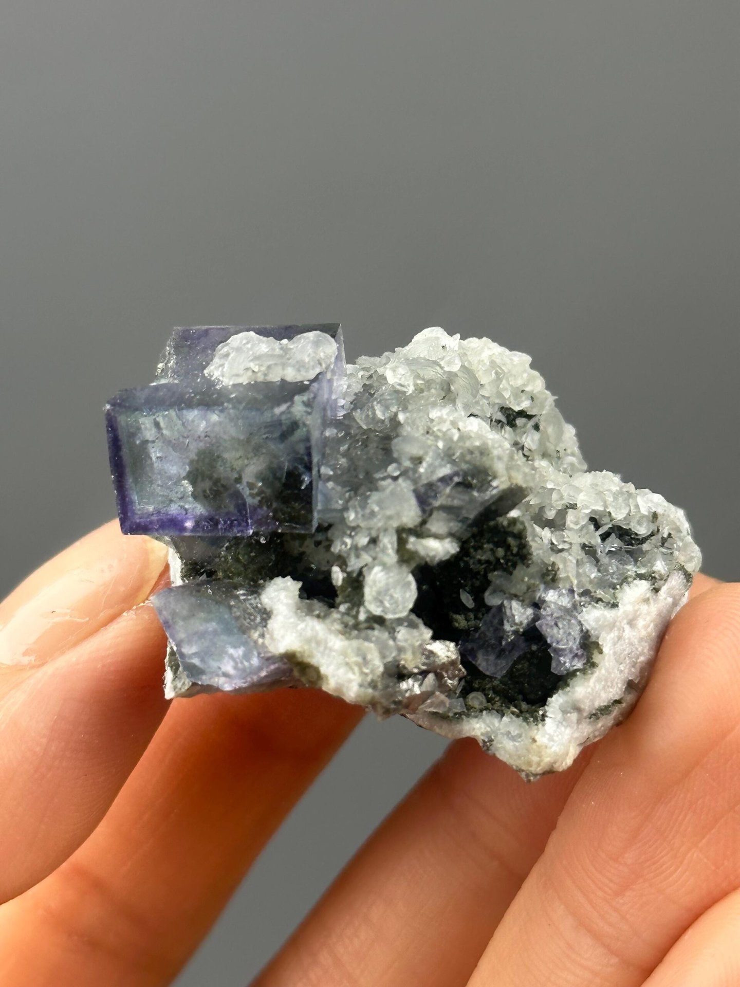 Front view of twinned purple phantom fluorite with quartz
