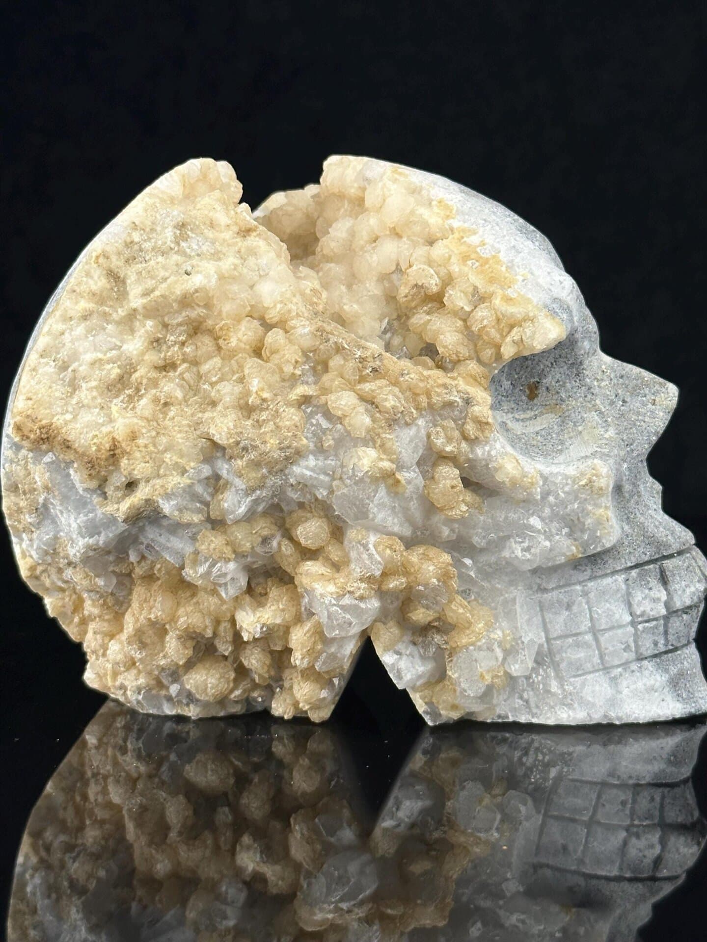 Detail of druzy quartz crystals inside extra-large carved skull